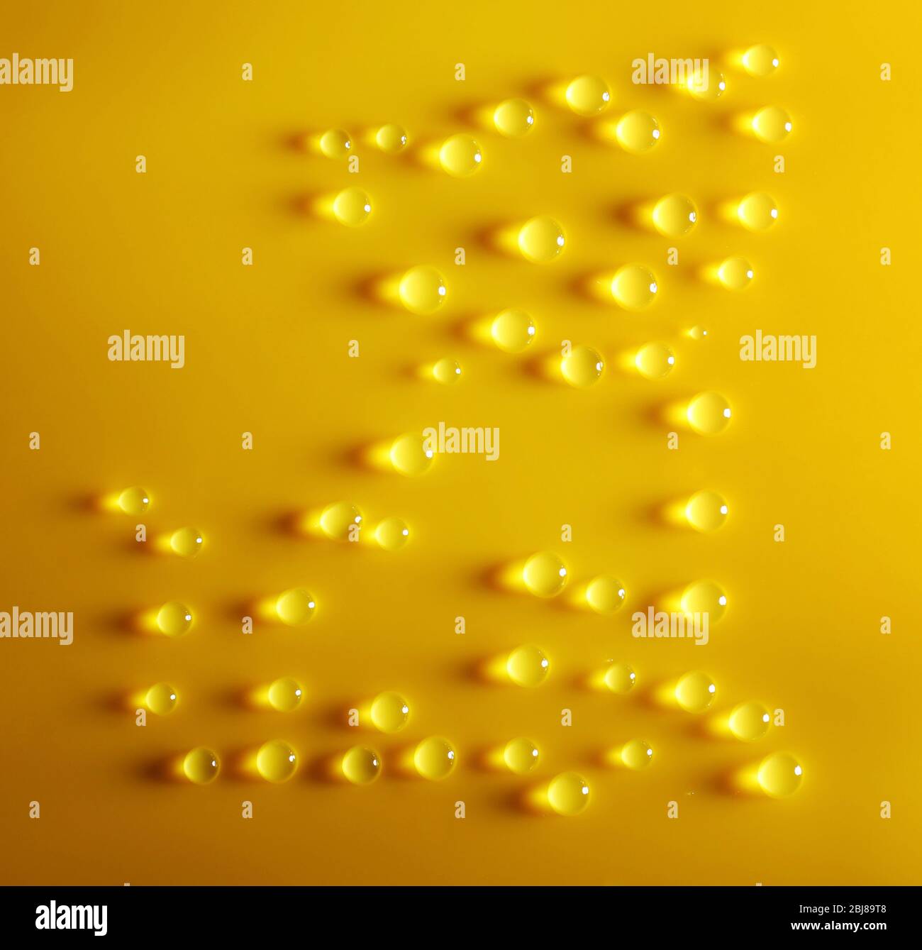 Cat made of water drops on yellow background Stock Photo Alamy