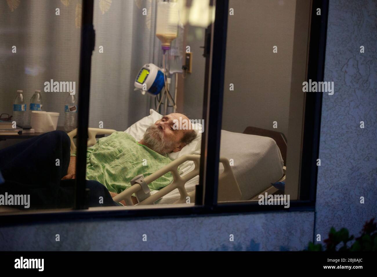Porterville, United States. 27th Apr, 2020. Jerry Hogan, a Vietnam Veteran, lies on a bed at Lindsey Gardens after testing positive for COVID-19/Coronavirus, a week earlier Hogan had been in the hospital, where he had pneumonia unrelated to Coronavirus, and had tested negative, when he was sent to a skilled nursing facility for rehabilitation, then there was an outbreak at the facility where he then tested positive a few days later. Credit: SOPA Images Limited/Alamy Live News Stock Photo