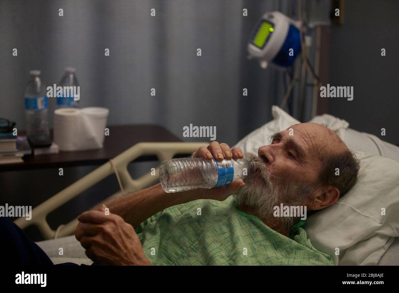 Porterville, United States. 27th Apr, 2020. Jerry Hogan, a Vietnam Veteran, lies on a bed at Lindsey Gardens after testing positive for COVID-19/Coronavirus, a week earlier Hogan had been in the hospital, where he had pneumonia unrelated to Coronavirus, and had tested negative, when he was sent to a skilled nursing facility for rehabilitation, then there was an outbreak at the facility, where he then tested positive a few days later. Credit: SOPA Images Limited/Alamy Live News Stock Photo