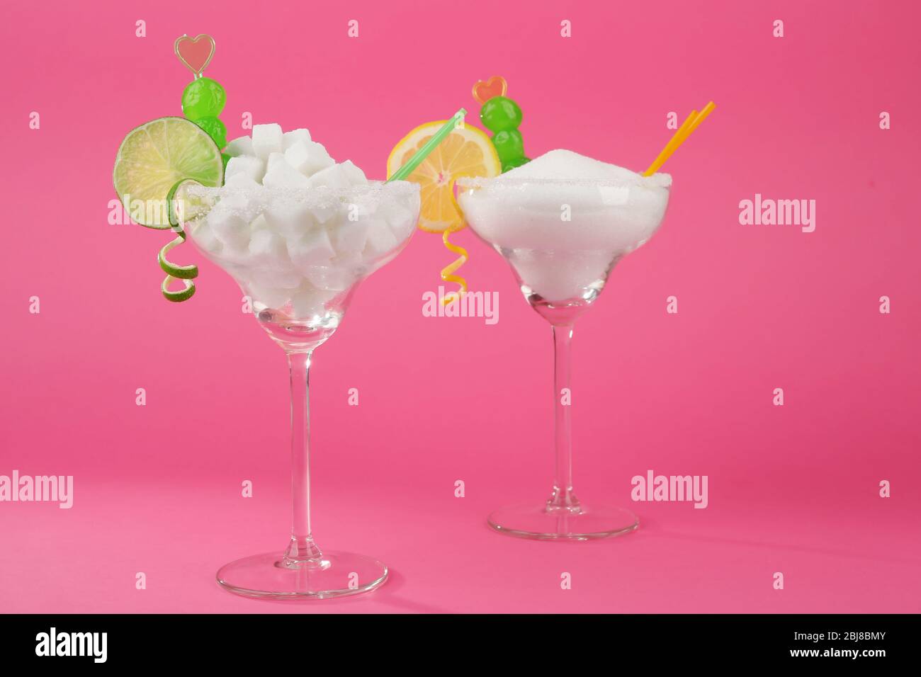 Margarita glasses with lump, granulated sugar, cocktail straws and
