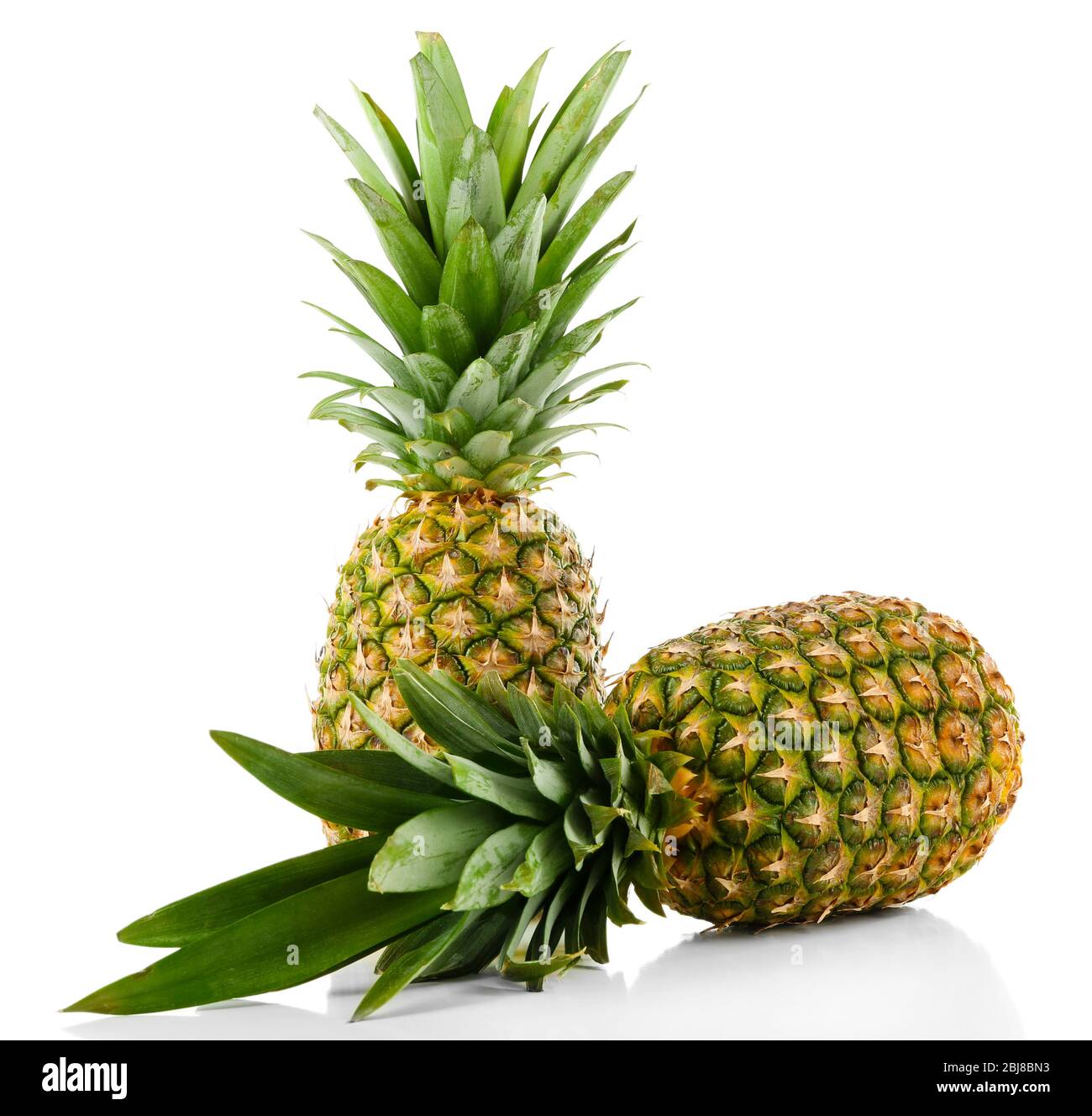 Two ripe fresh pineapples, isolated on white Stock Photo
