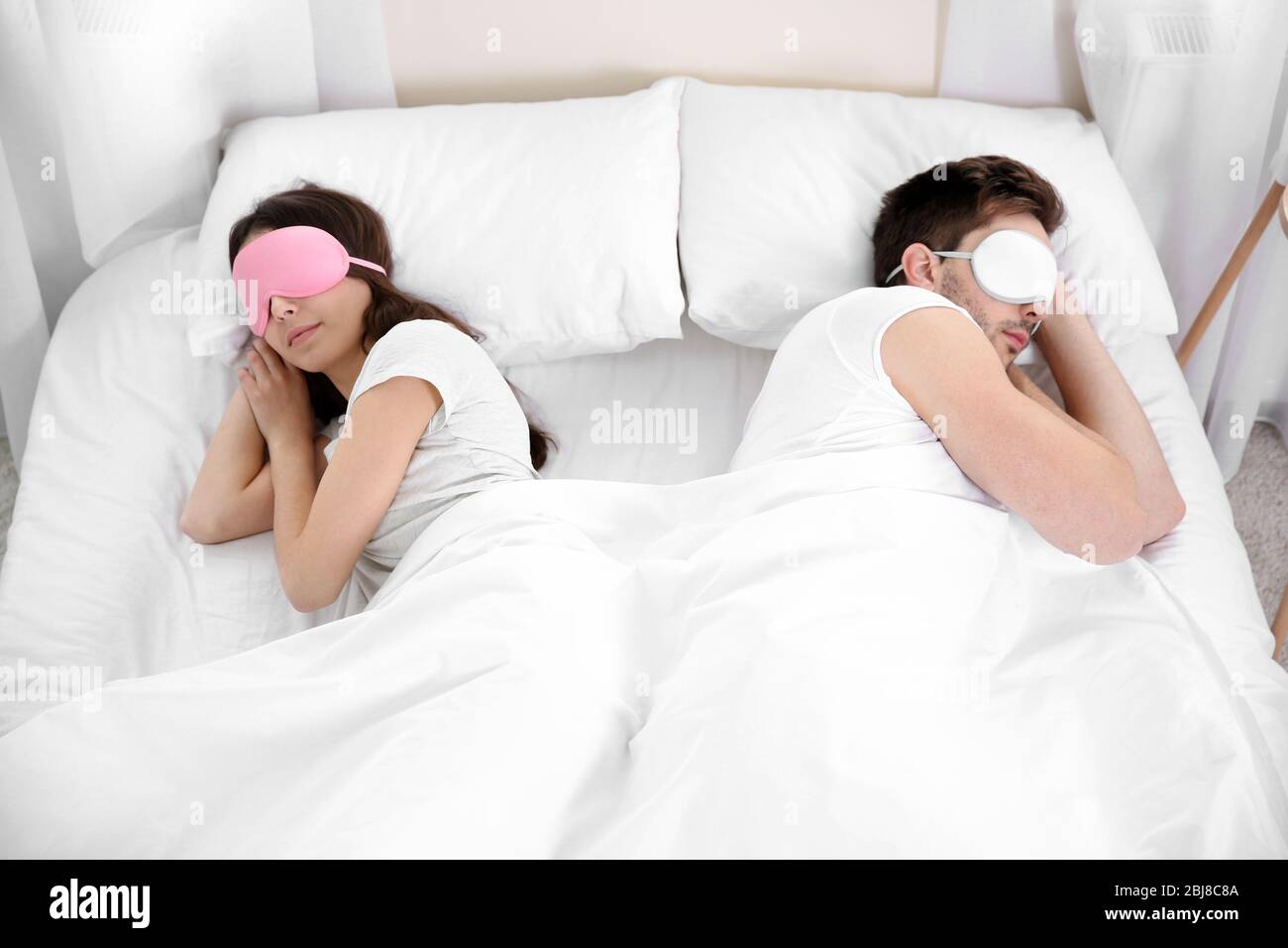 Young cute couple sleeping in eye masks Stock Photo Alamy