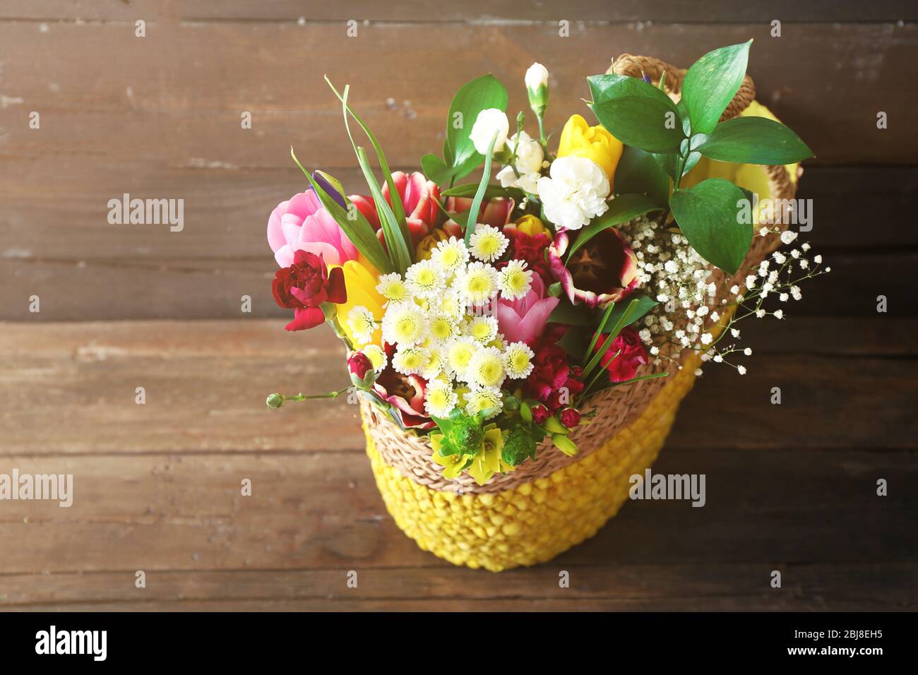 Bouquet of fresh flowers in a wicker basket Stock Photo - Alamy