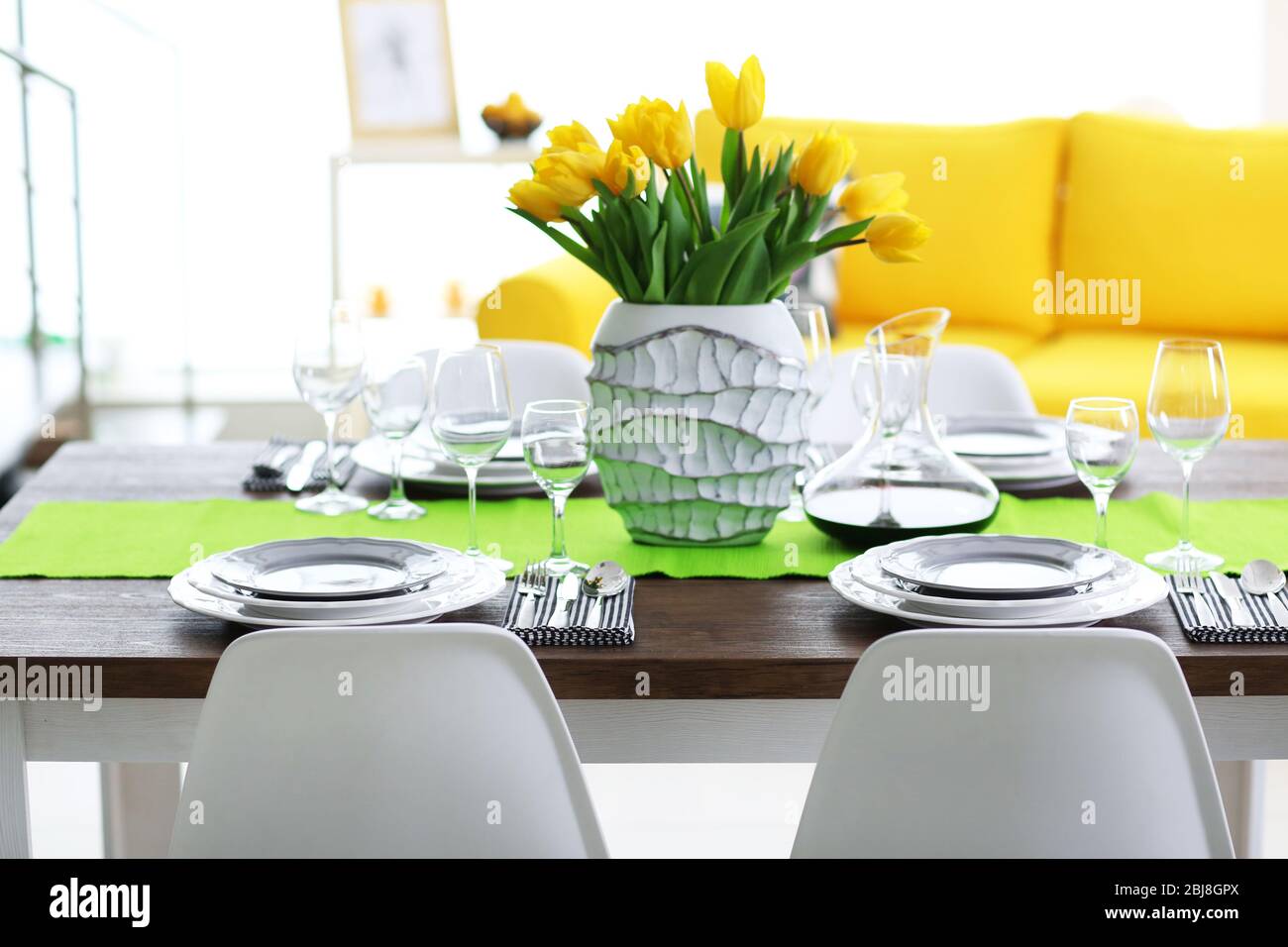 Dining room interior with sofa and table served for dinner Stock Photo ...