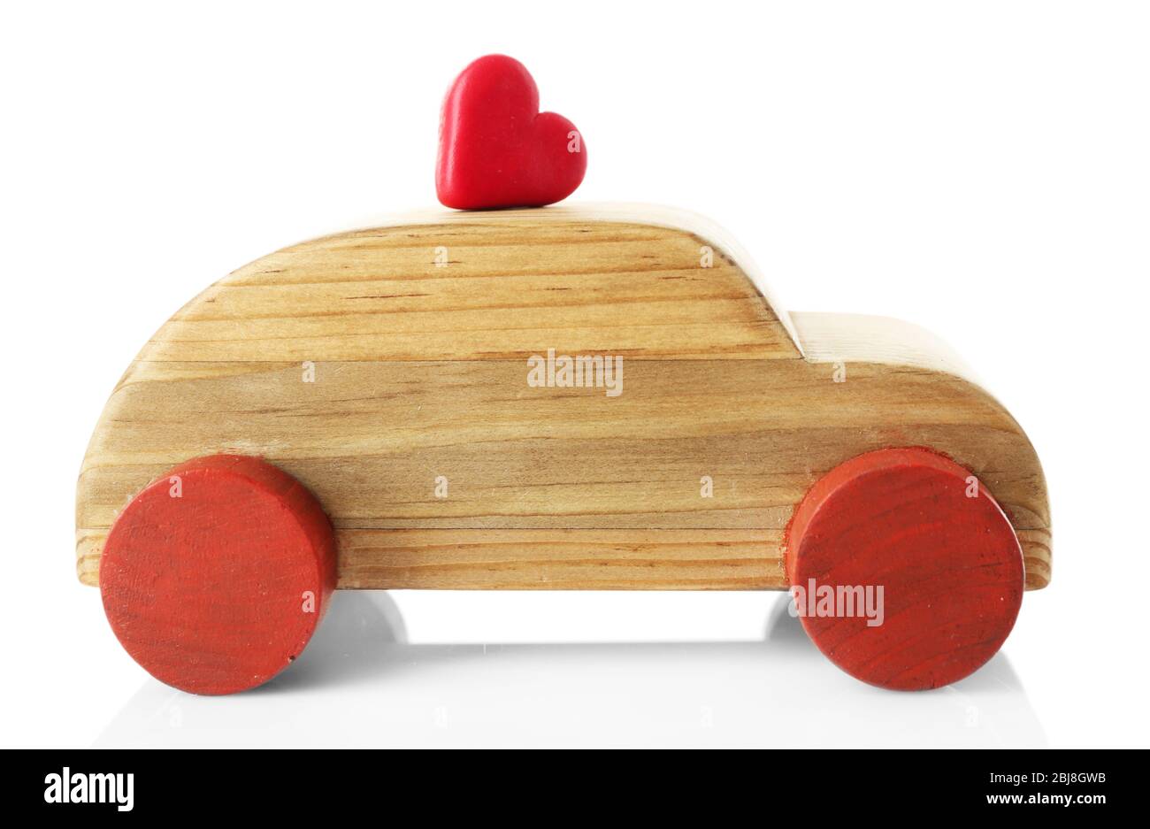 Wooden car with a little red heart figure isolated on white Stock Photo