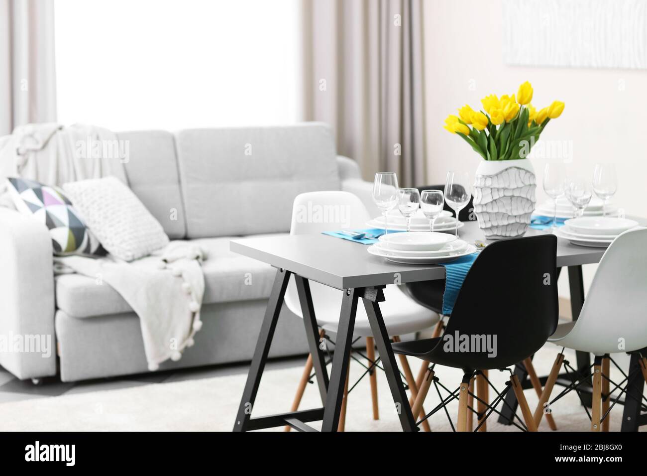 Dining room interior with sofa and table served for dinner Stock Photo ...