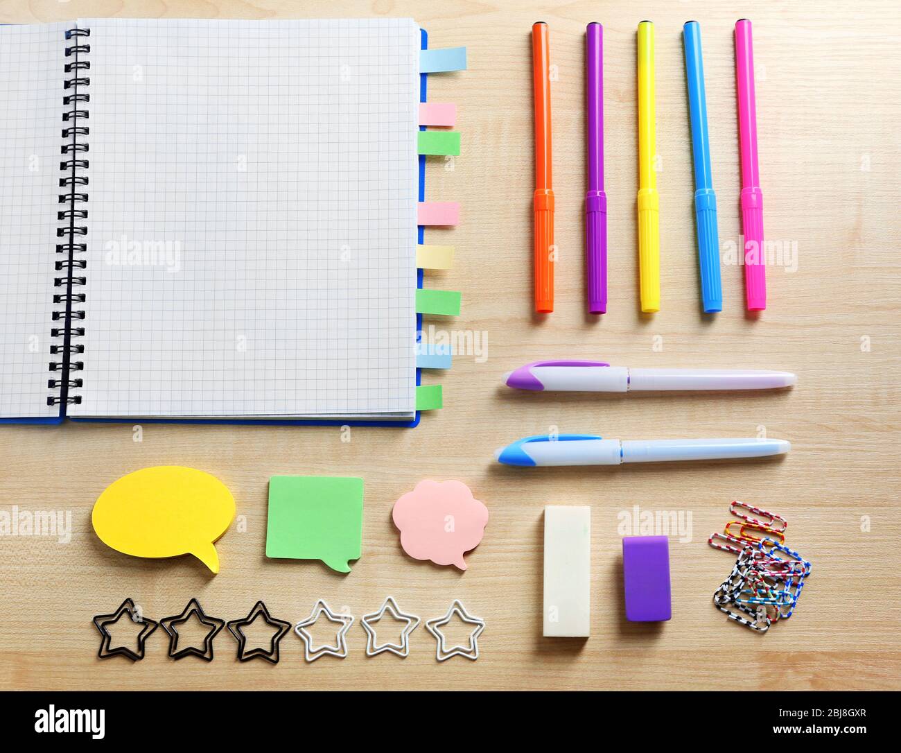 https://c8.alamy.com/comp/2BJ8GXR/notebook-with-bookmarks-on-wooden-table-2BJ8GXR.jpg