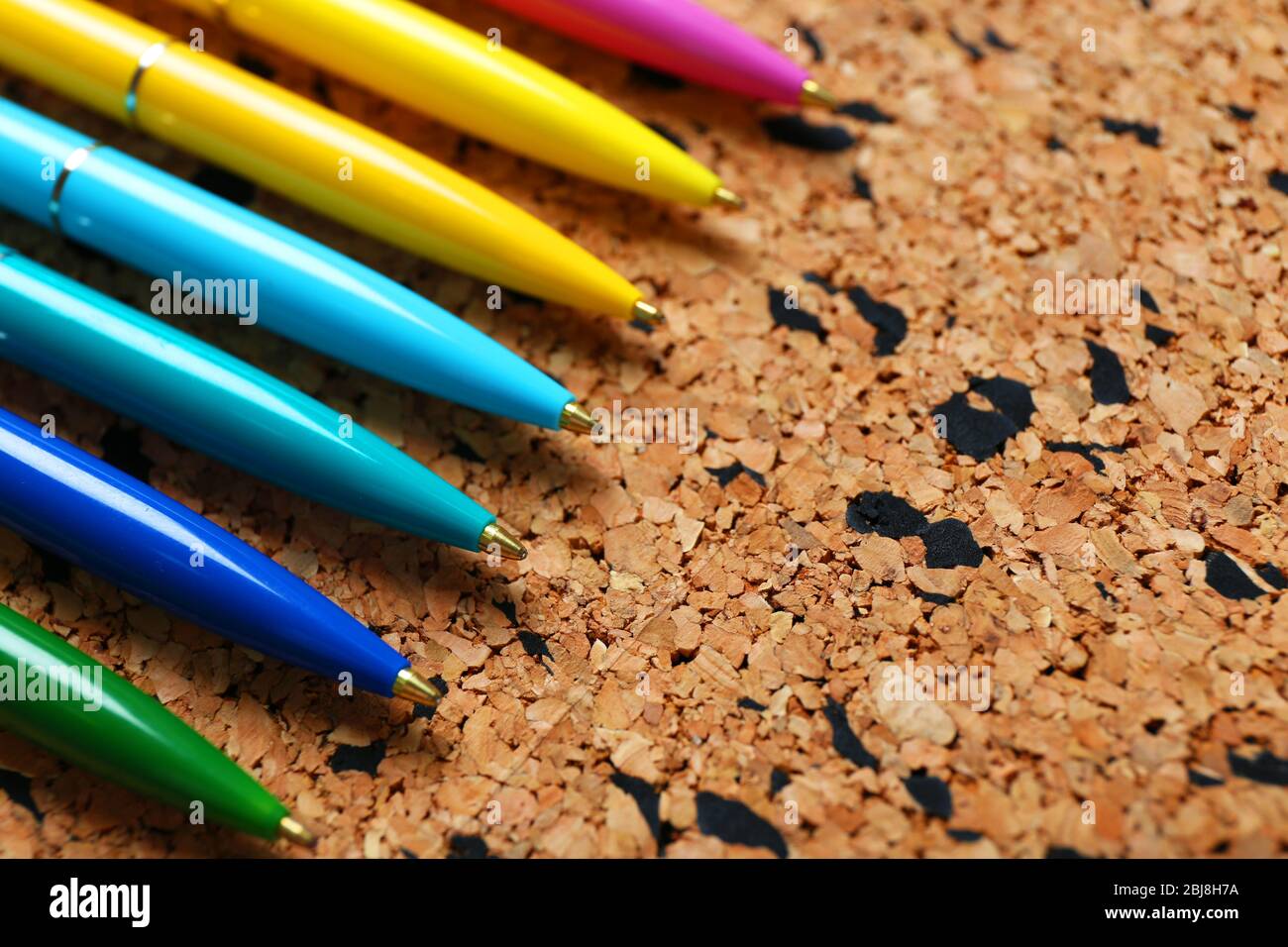Colour pens on cork board background Stock Photo Alamy