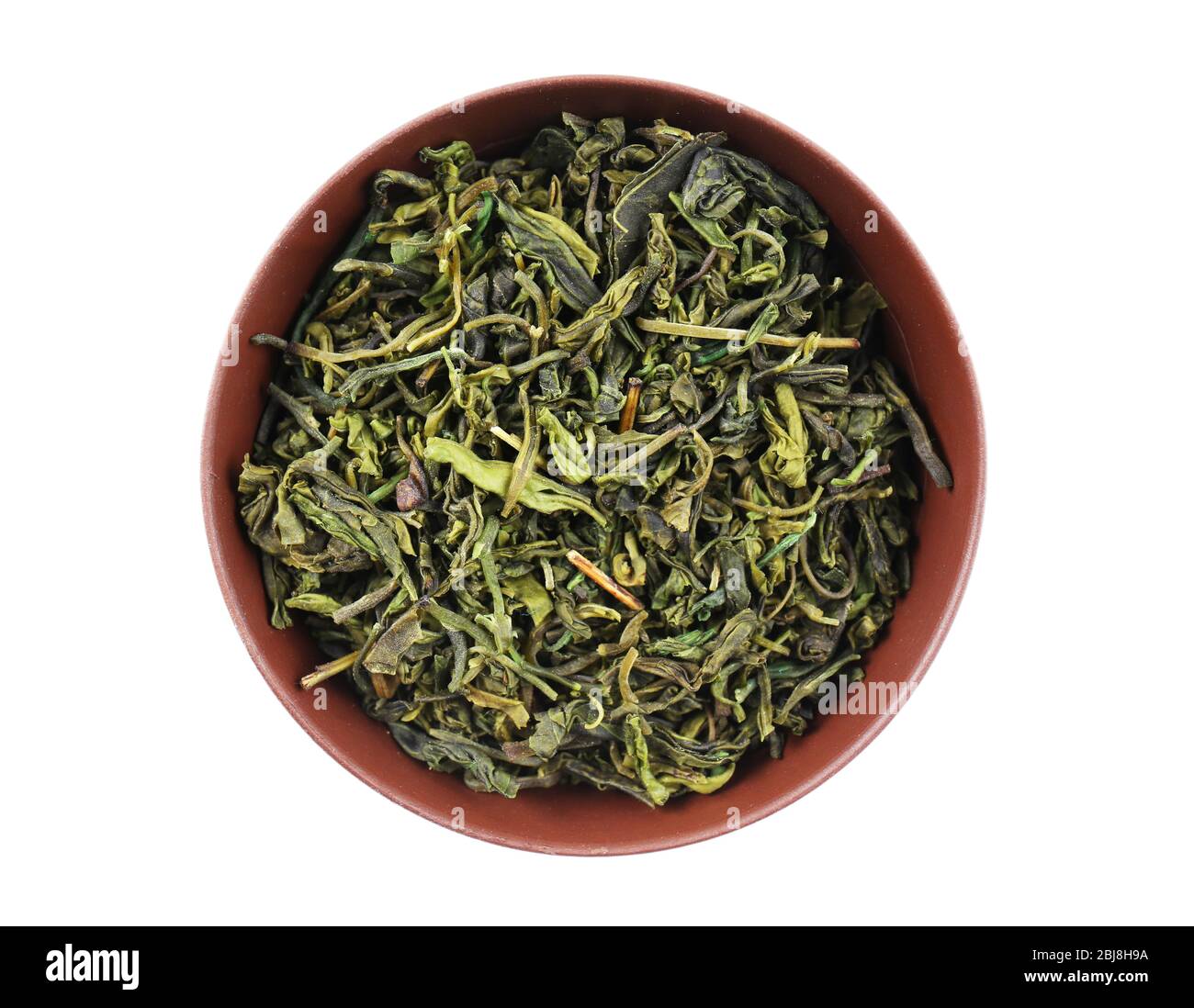 Dry tea in saucer isolated on white Stock Photo Alamy