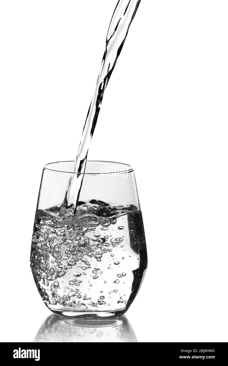 Pouring water into glass over grey background Stock Photo Alamy
