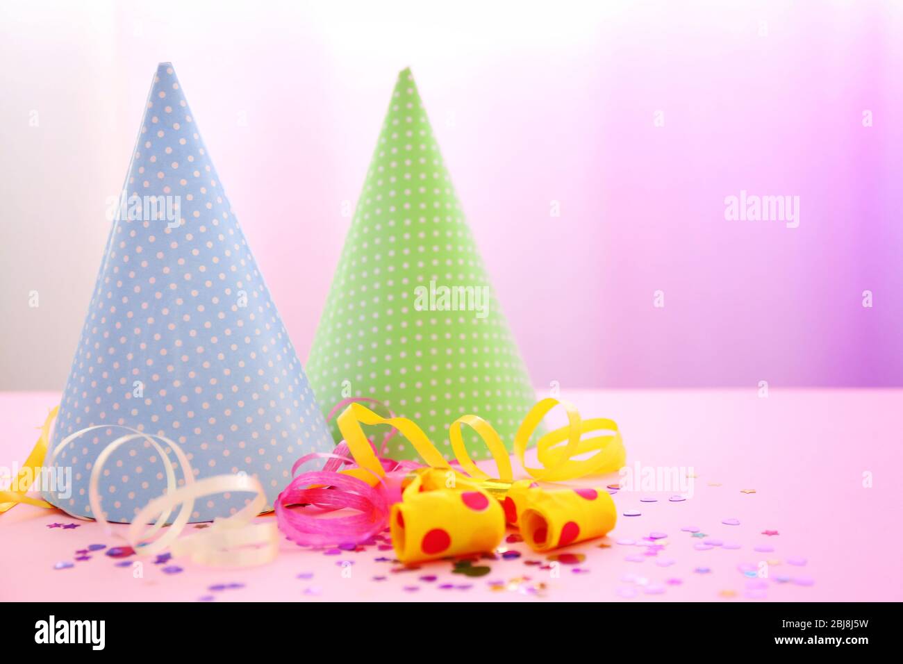 Party hats on bright background Stock Photo - Alamy