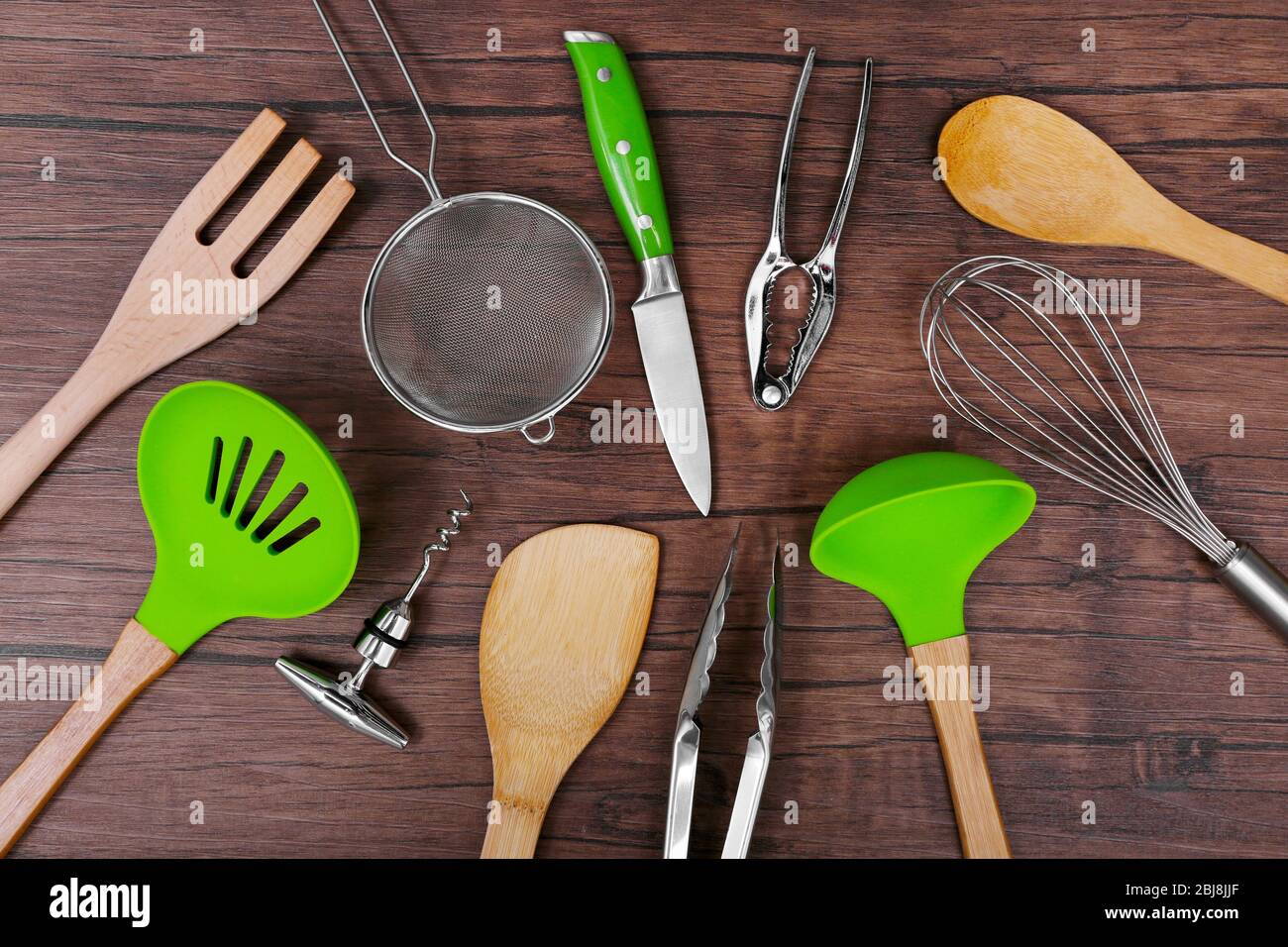 Set of stainless and wooden utensils on wooden background Stock Photo ...