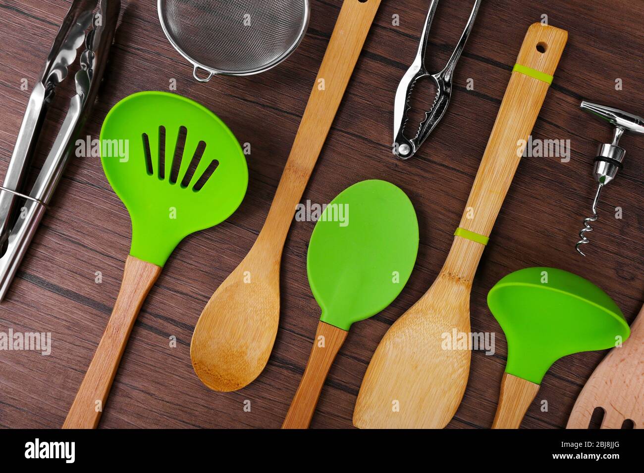 Set of stainless and wooden utensils on wooden background Stock Photo
