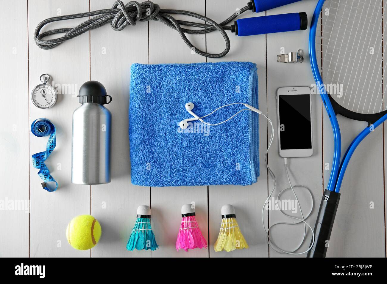 Sport equipment with mobile phone on white wooden background Stock Photo
