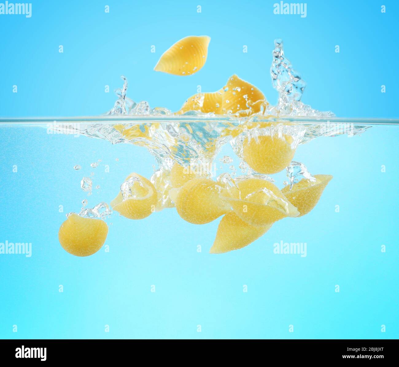 Falling pasta in water Stock Photo