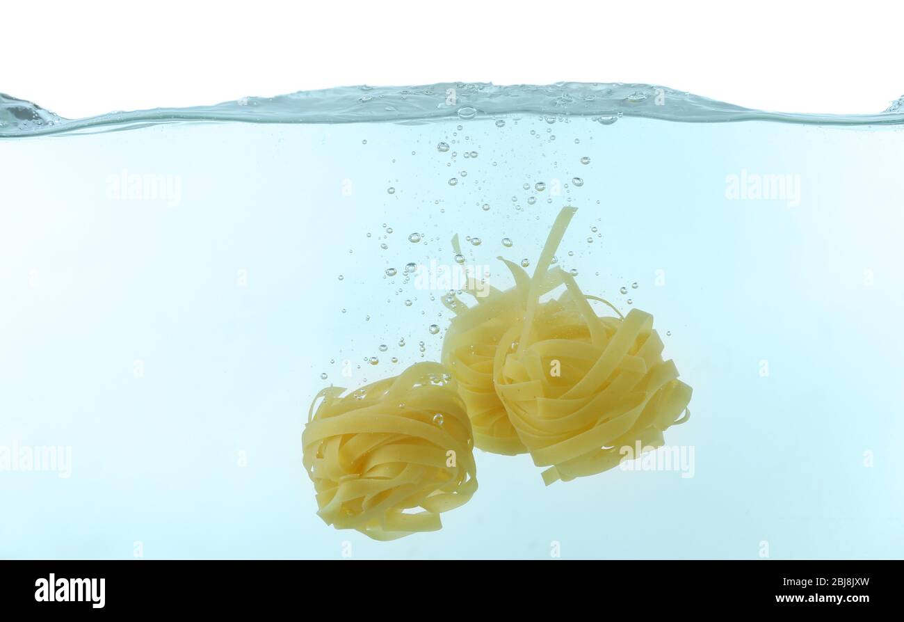 Falling pasta in water Stock Photo