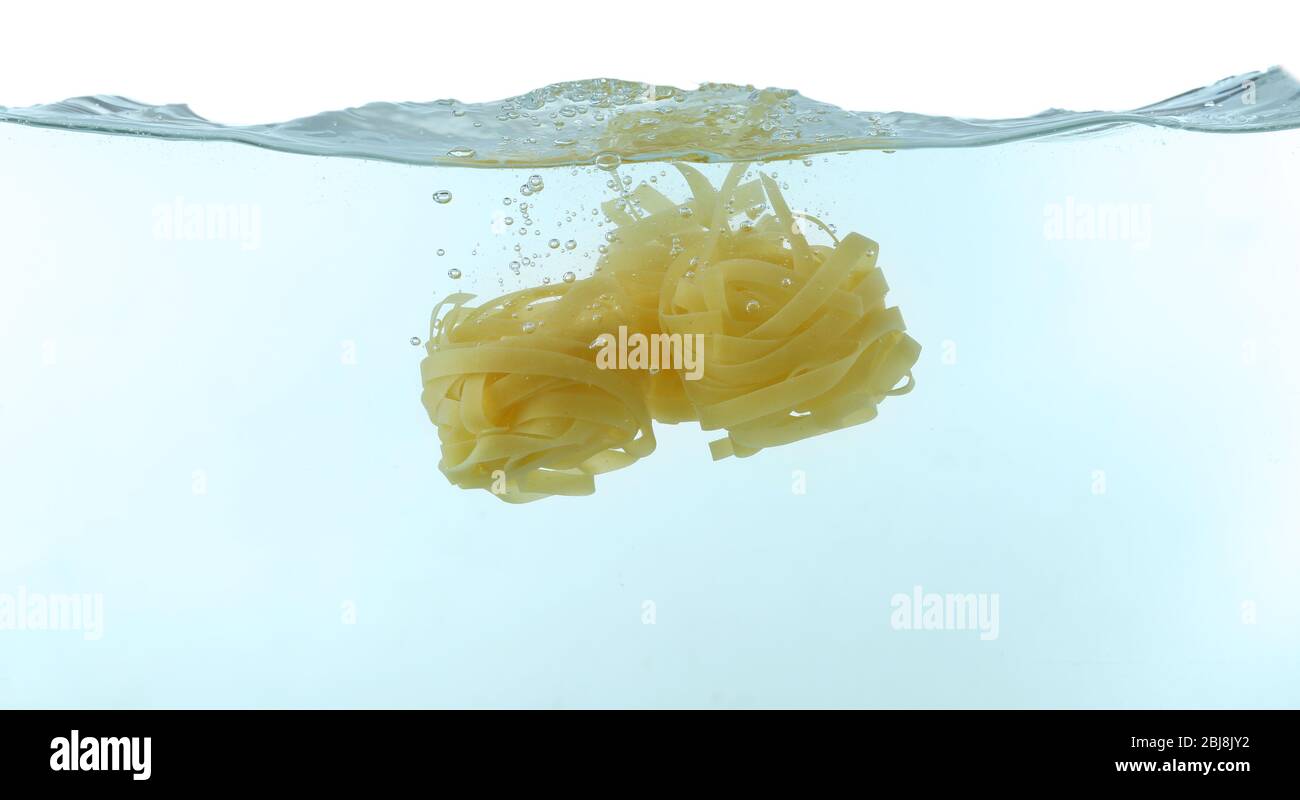 Falling pasta in water Stock Photo