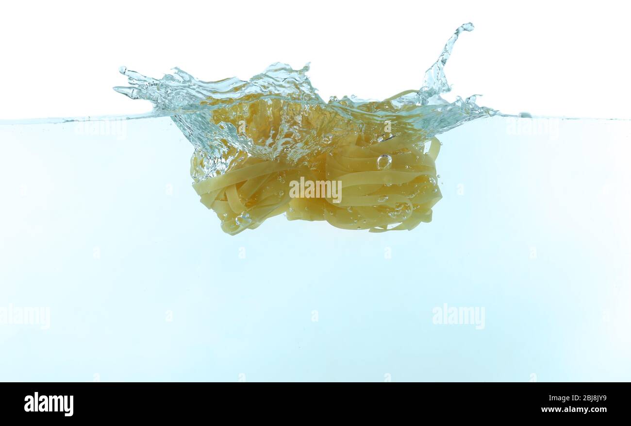 Falling pasta in water Stock Photo