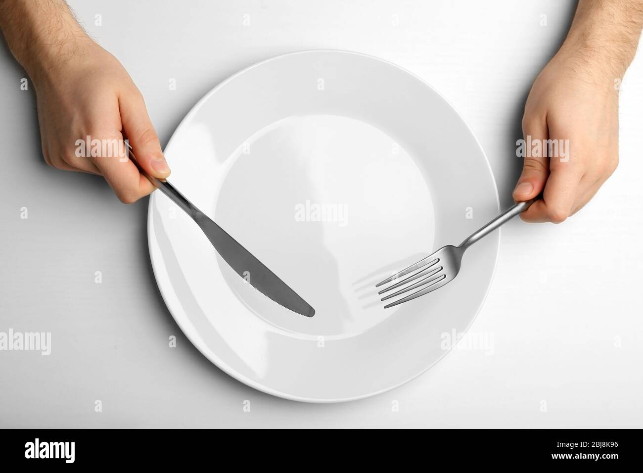 Man holding knife fork ready hi-res stock photography and images - Alamy