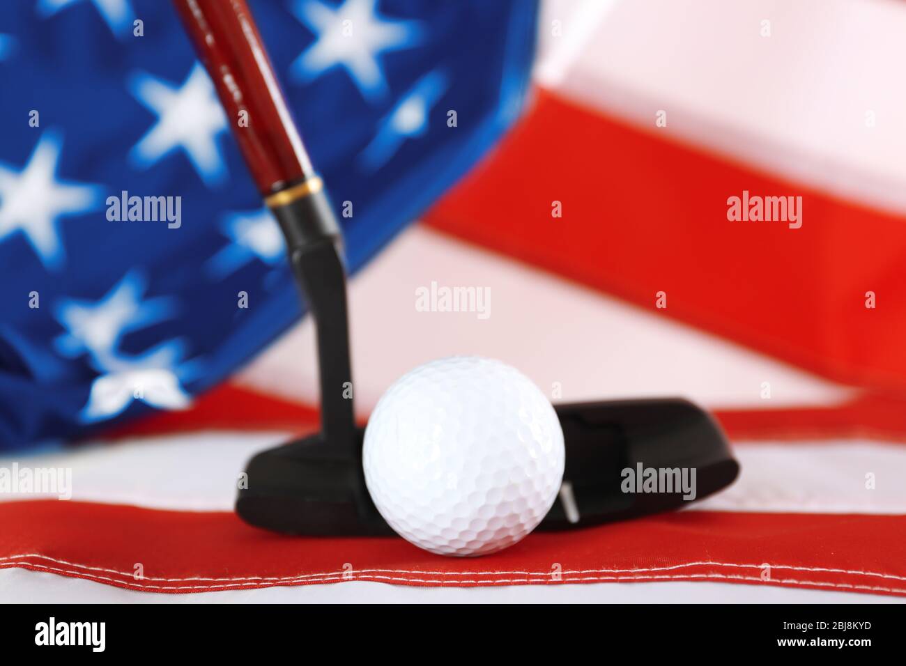 Golf ball and club on background of American flag. Popular sport