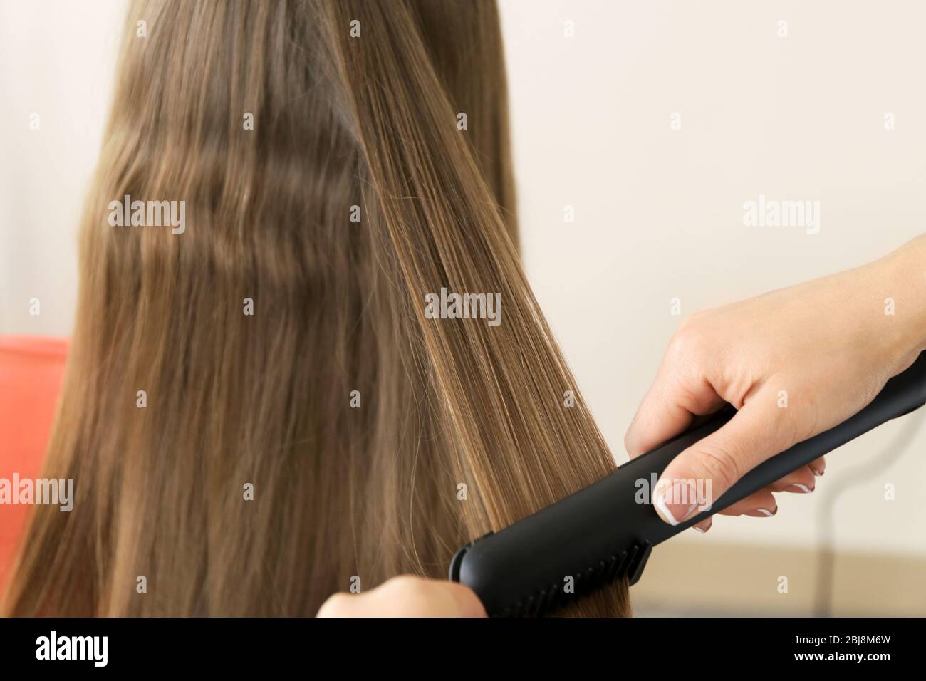 hairdresser straightening hair
