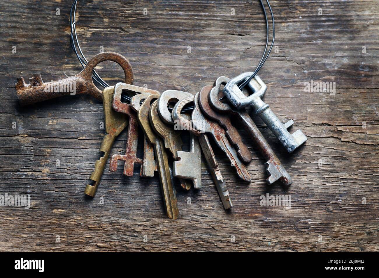 Bunch of old keys on wooden background Stock Photo