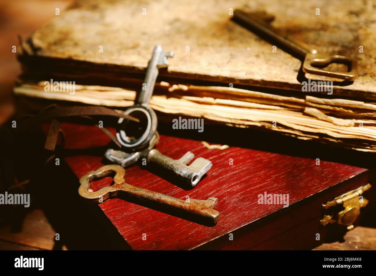 Keys with old book and box, close up Stock Photo