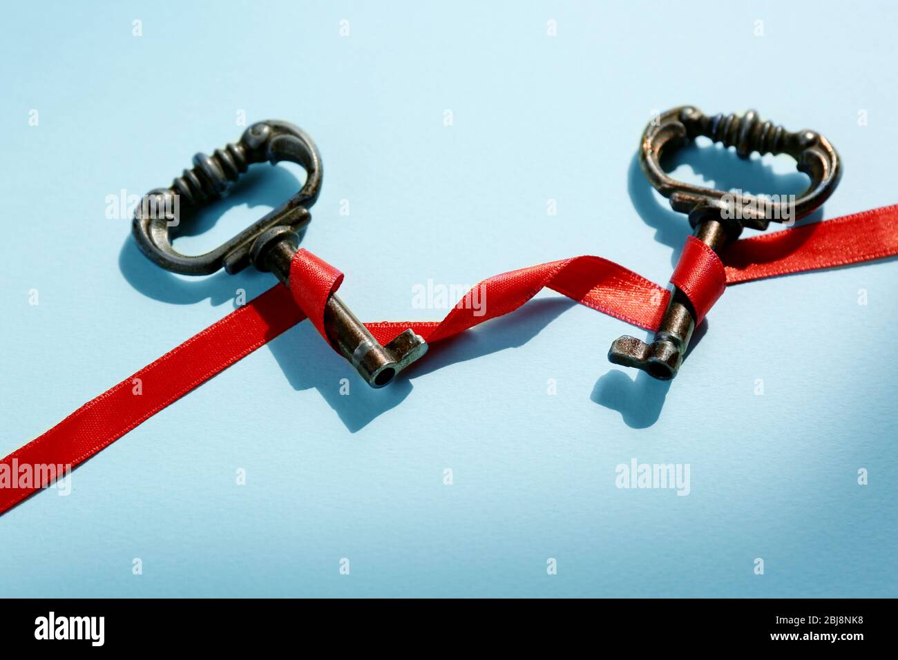 Ribble Key Vintage key with a red ribbon on a light blue background Stock Photo ...