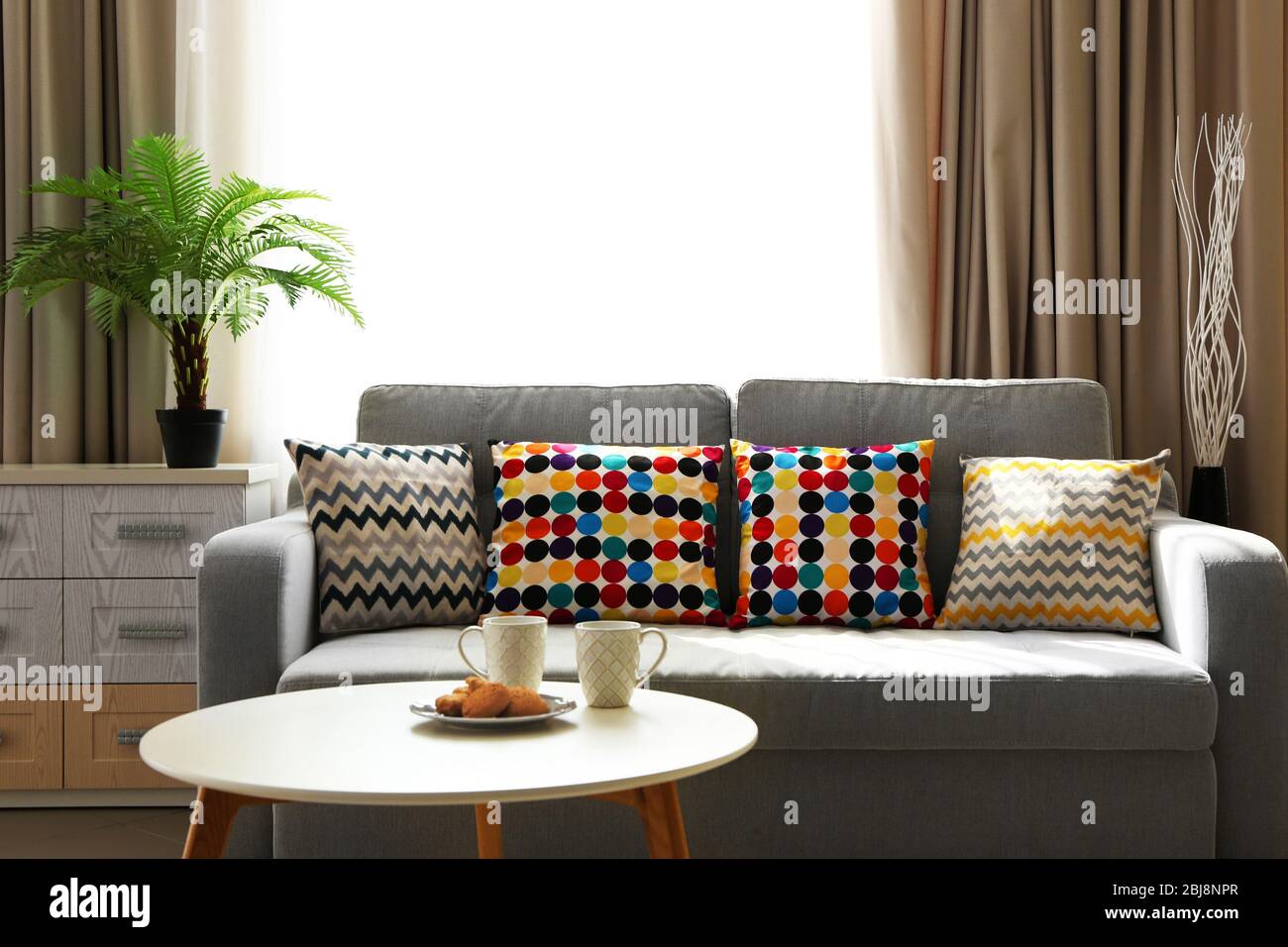 Living room design interior with sofa and round table Stock Photo - Alamy