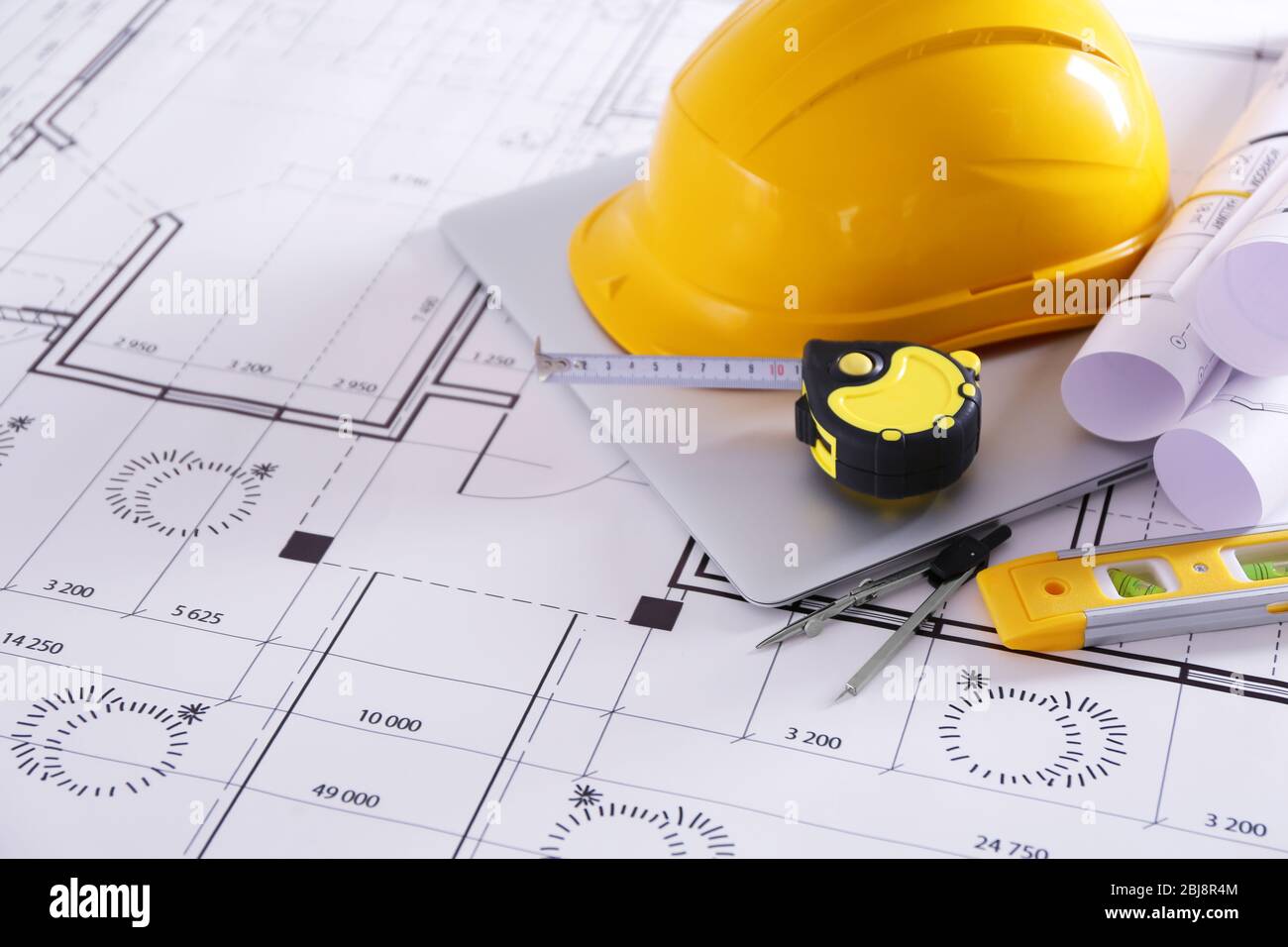 Construction blueprints with tools and helmet closeup Stock Photo - Alamy
