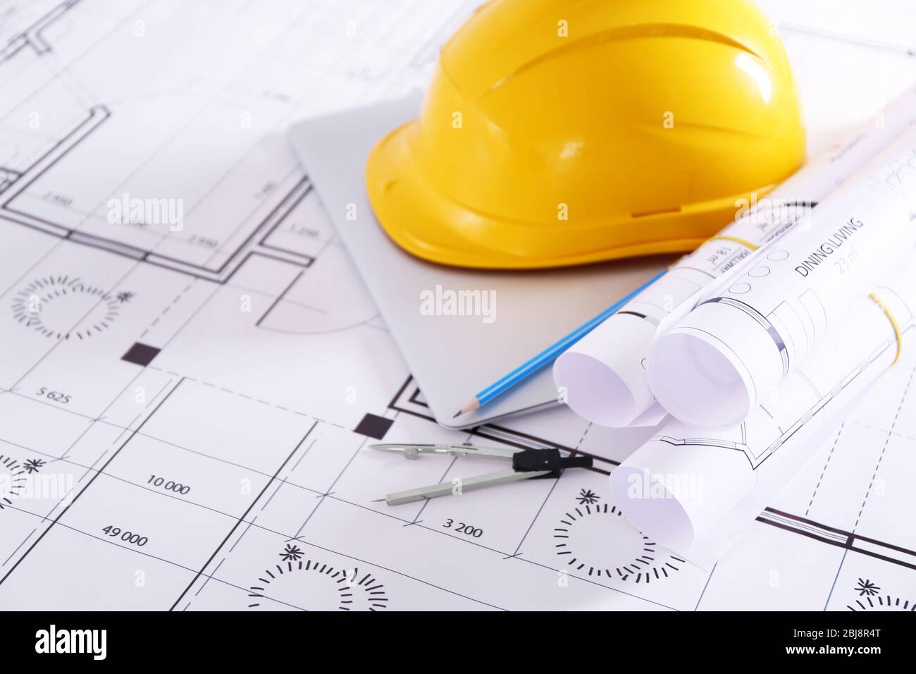Construction blueprints with tools and helmet closeup Stock Photo - Alamy