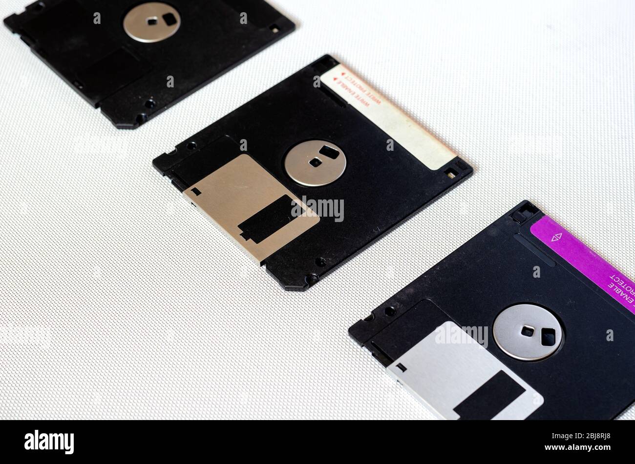 3.5 inch magnetic floppy disks. Three floppy disks with a capacity of 1.44 MB. Obsolete digital data storage media. Close-up. Selective focus. Stock Photo