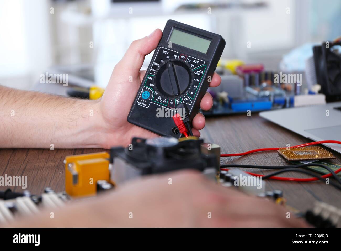 Male hands checking electronic hardware in service center Stock Photo
