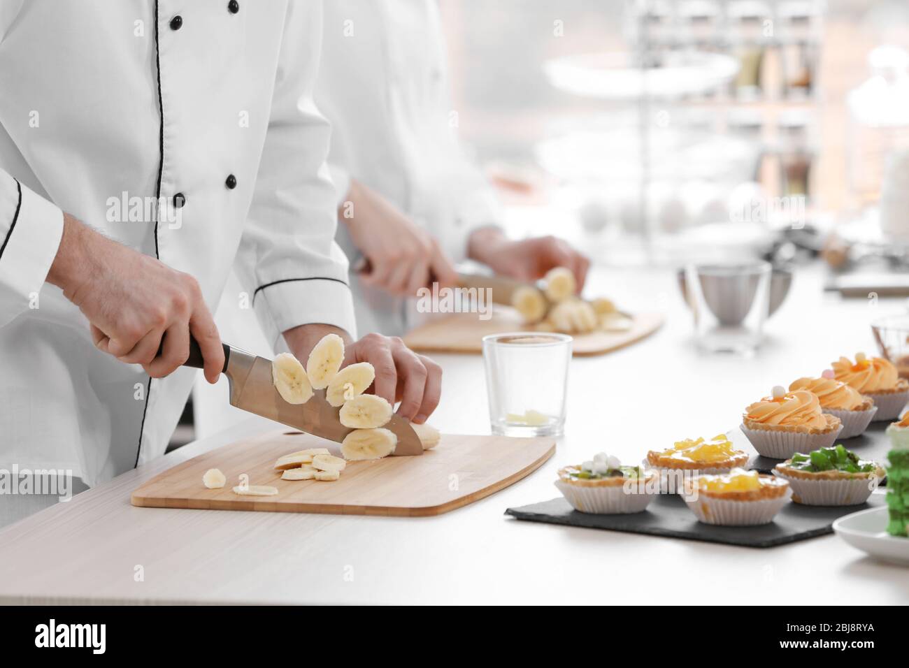 Chefs cutting banana on a wooden boards Stock Photo Alamy