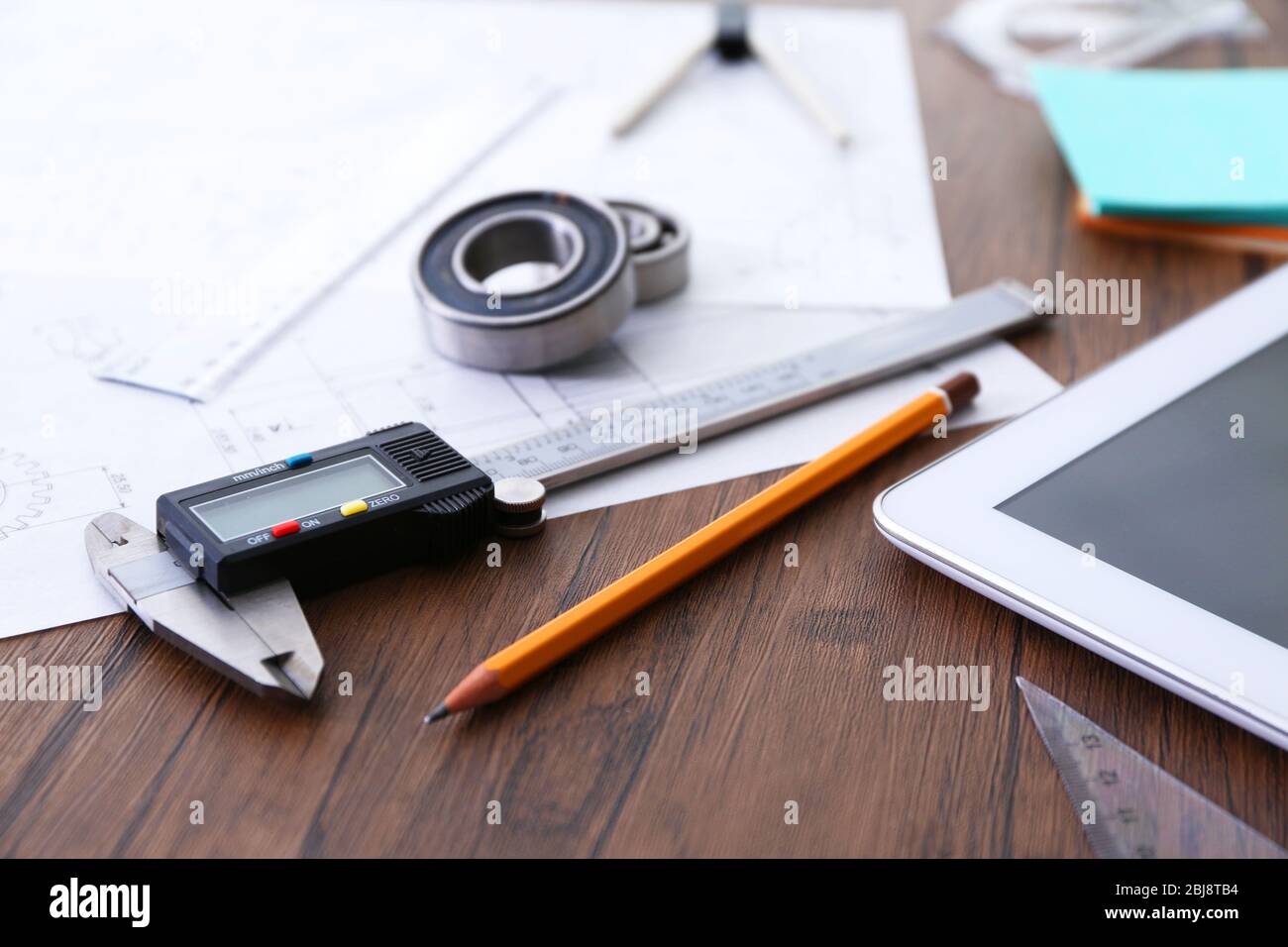 Engineering supplies and tablet on wooden background Stock Photo Alamy