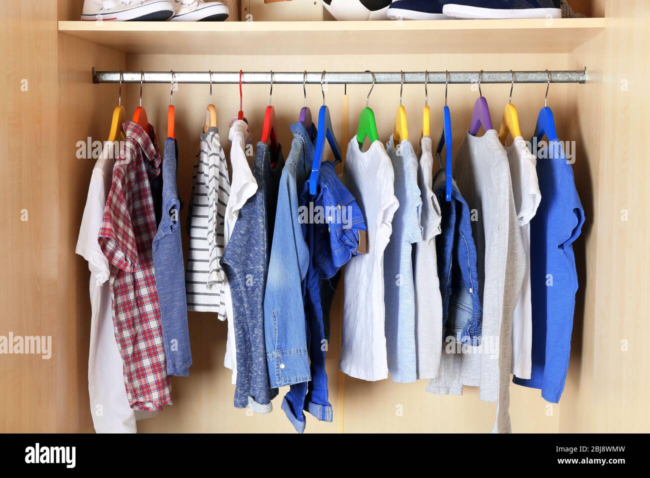 Boy clothes on hangers in the wardrobe Stock Photo - Alamy