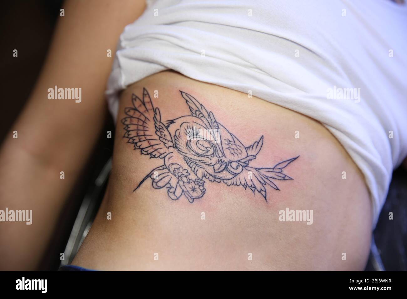 Pelvis tattoo of three birds on Bojana.