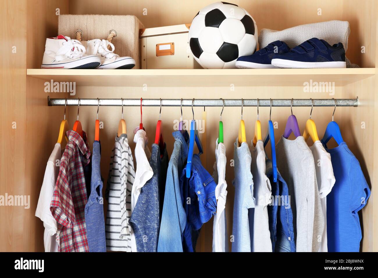 Boy clothes on hangers in the wardrobe Stock Photo