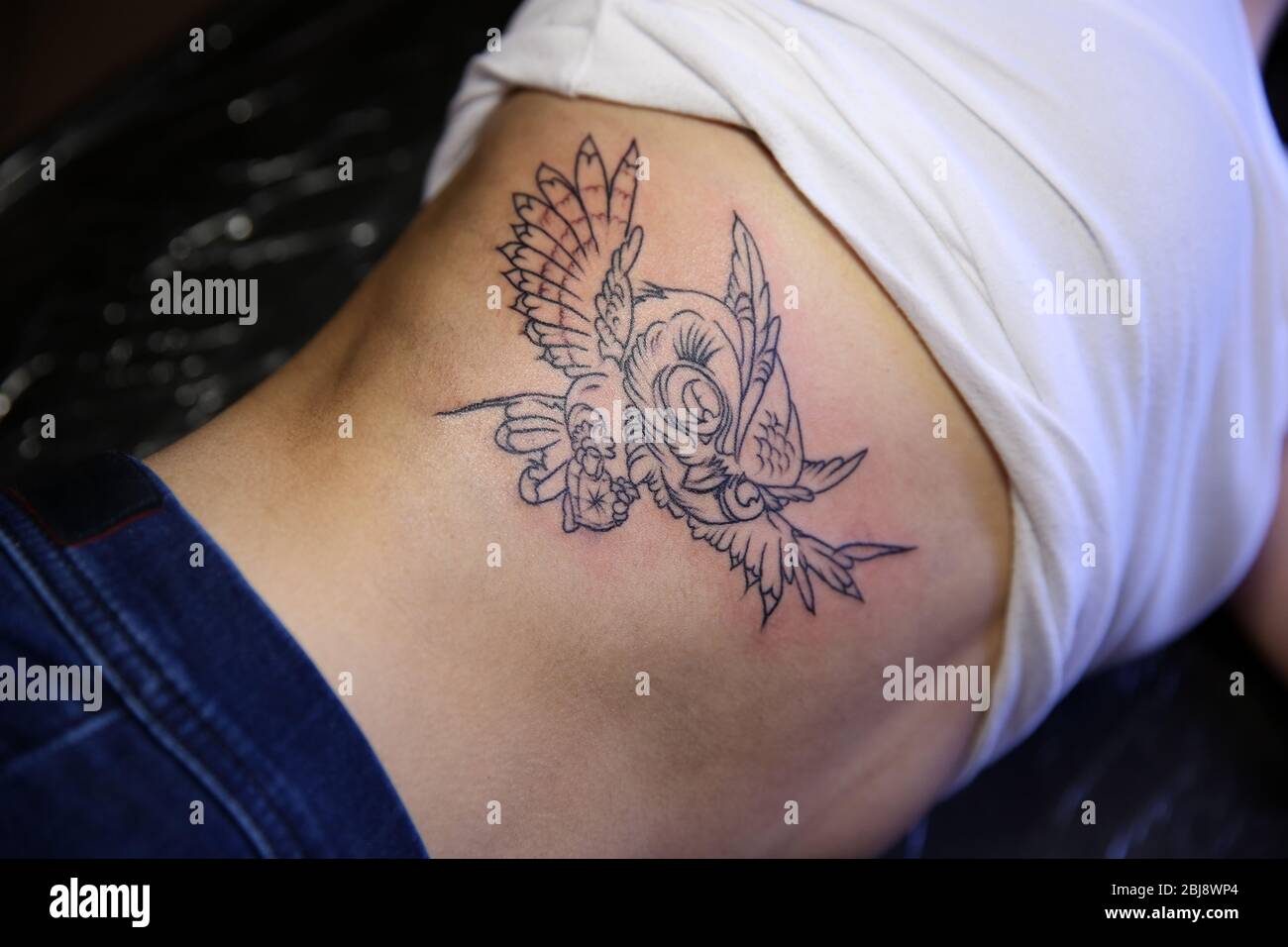 Wonderful Flying Bird With Flowers Tattoo On Right Front Shoulder