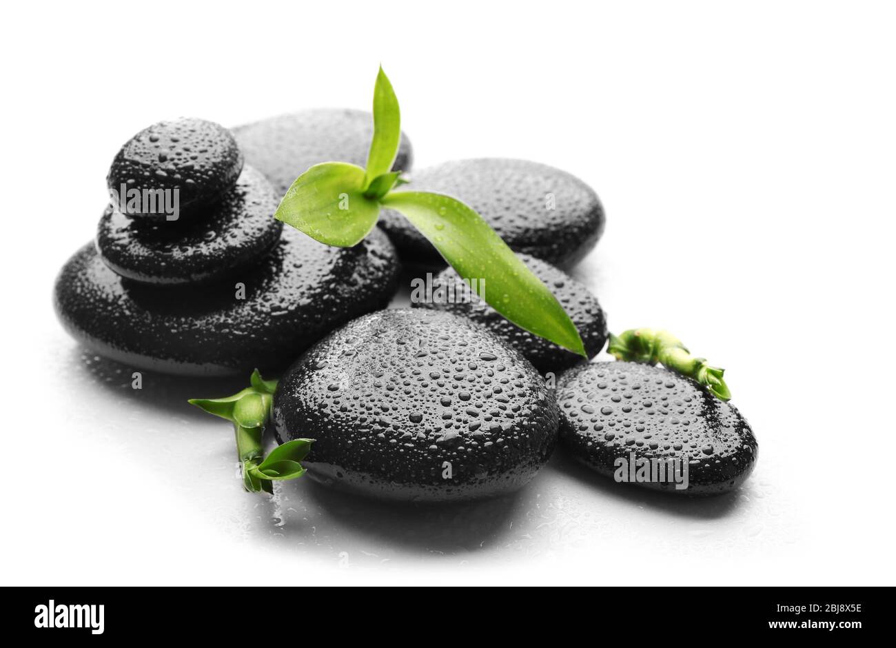 Heap of spa hot stones isolated on white Stock Photo - Alamy