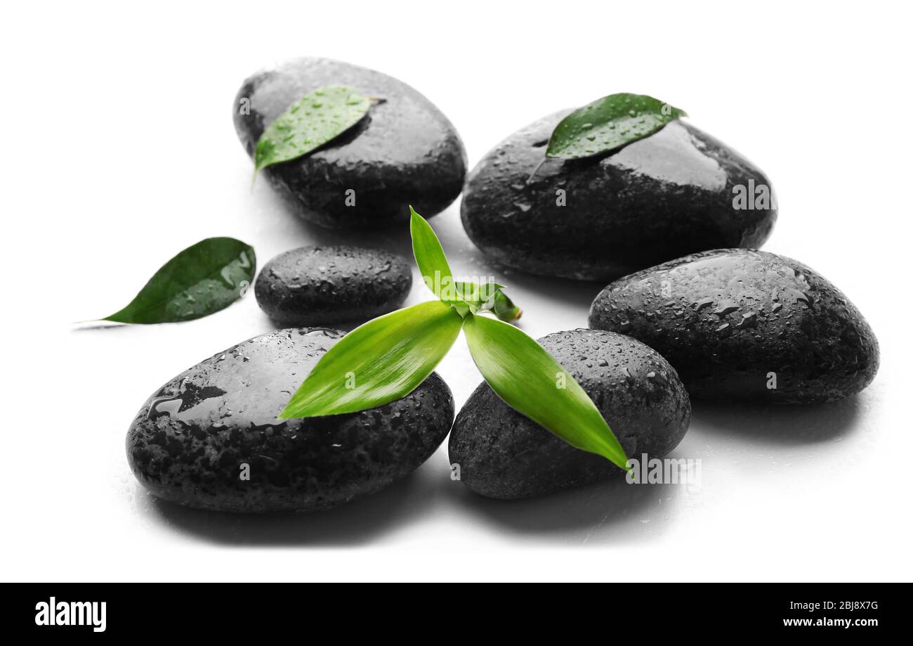 Heap of spa hot stones isolated on white Stock Photo - Alamy