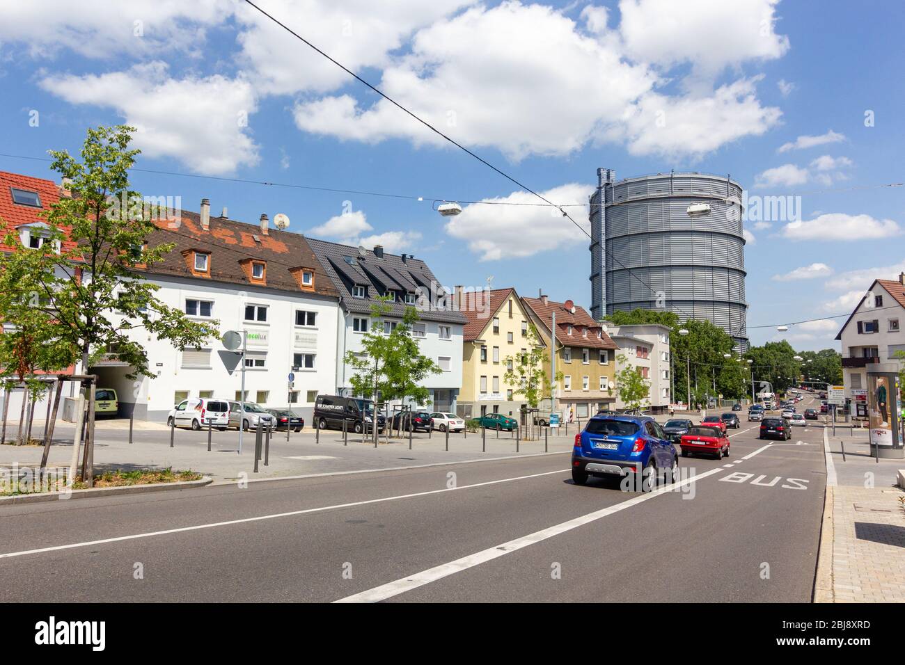 Stuttgart, Germany - July 2016: busy street with old german buildings of Gaisburg district in Stuttgart-Ost with view on Gaskessel Stuttgart tower wit Stock Photo