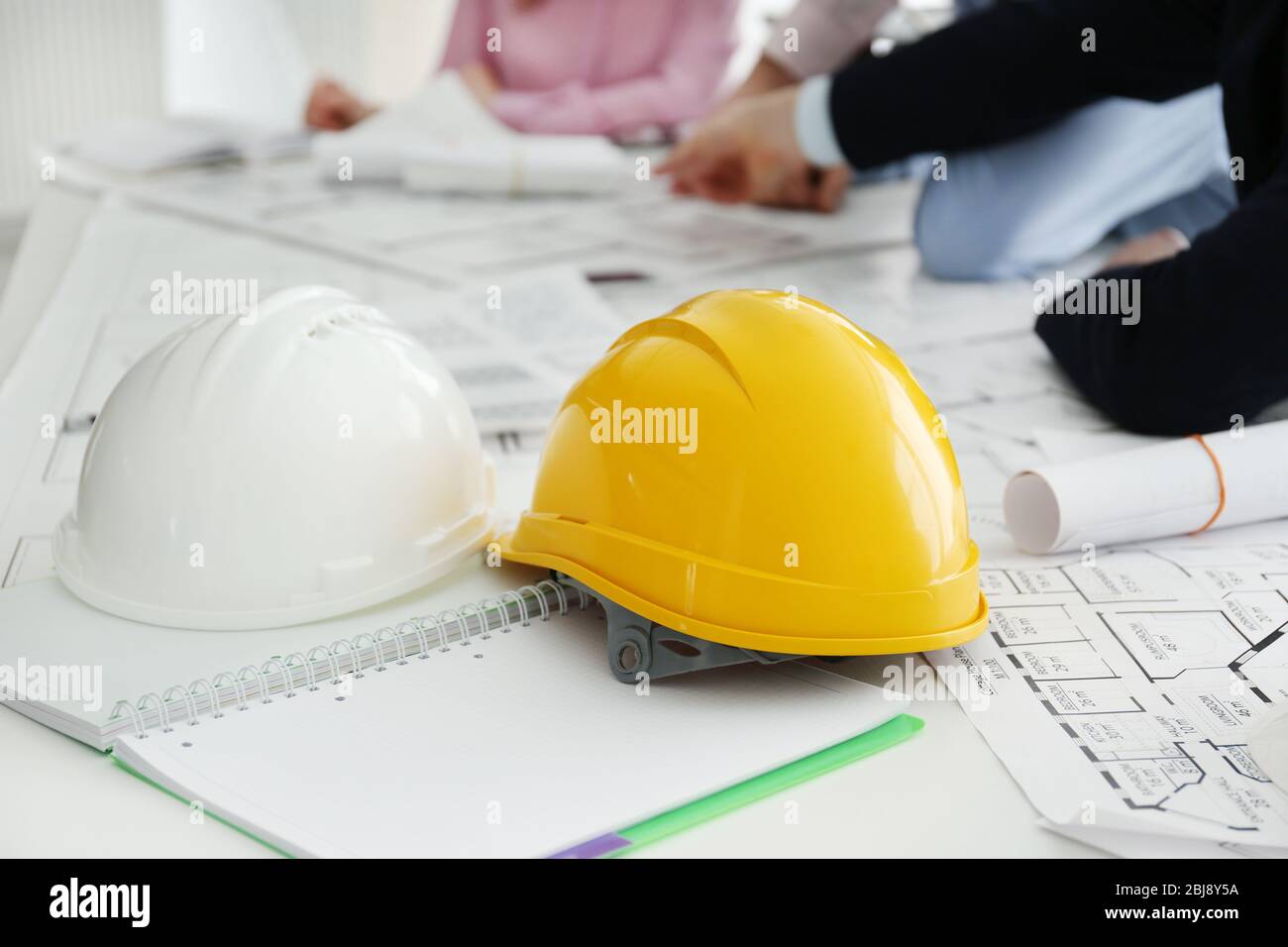 Helmets and blueprints on the office table Stock Photo