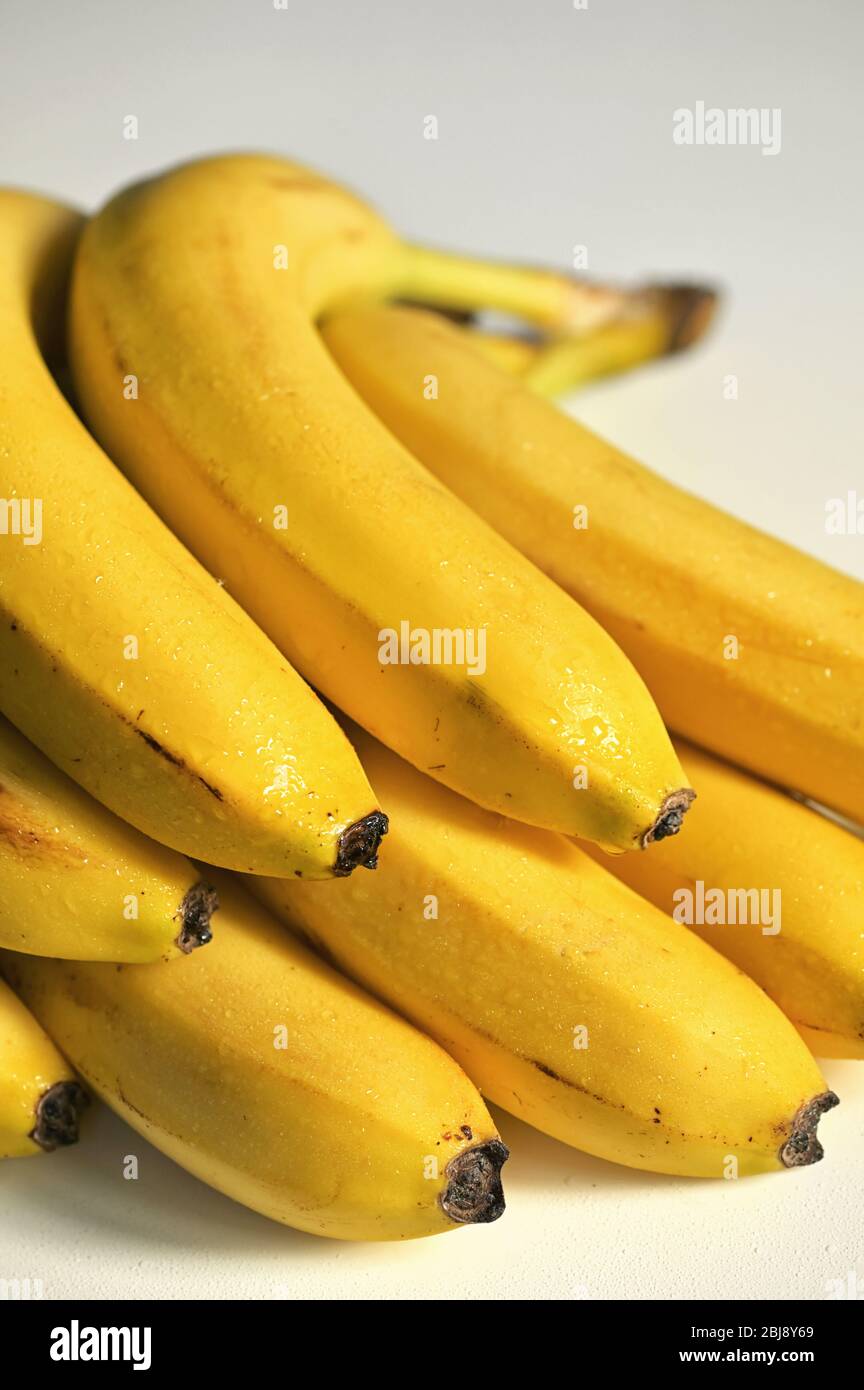 Bunch of raw ripe organic yellow bananas Stock Photo