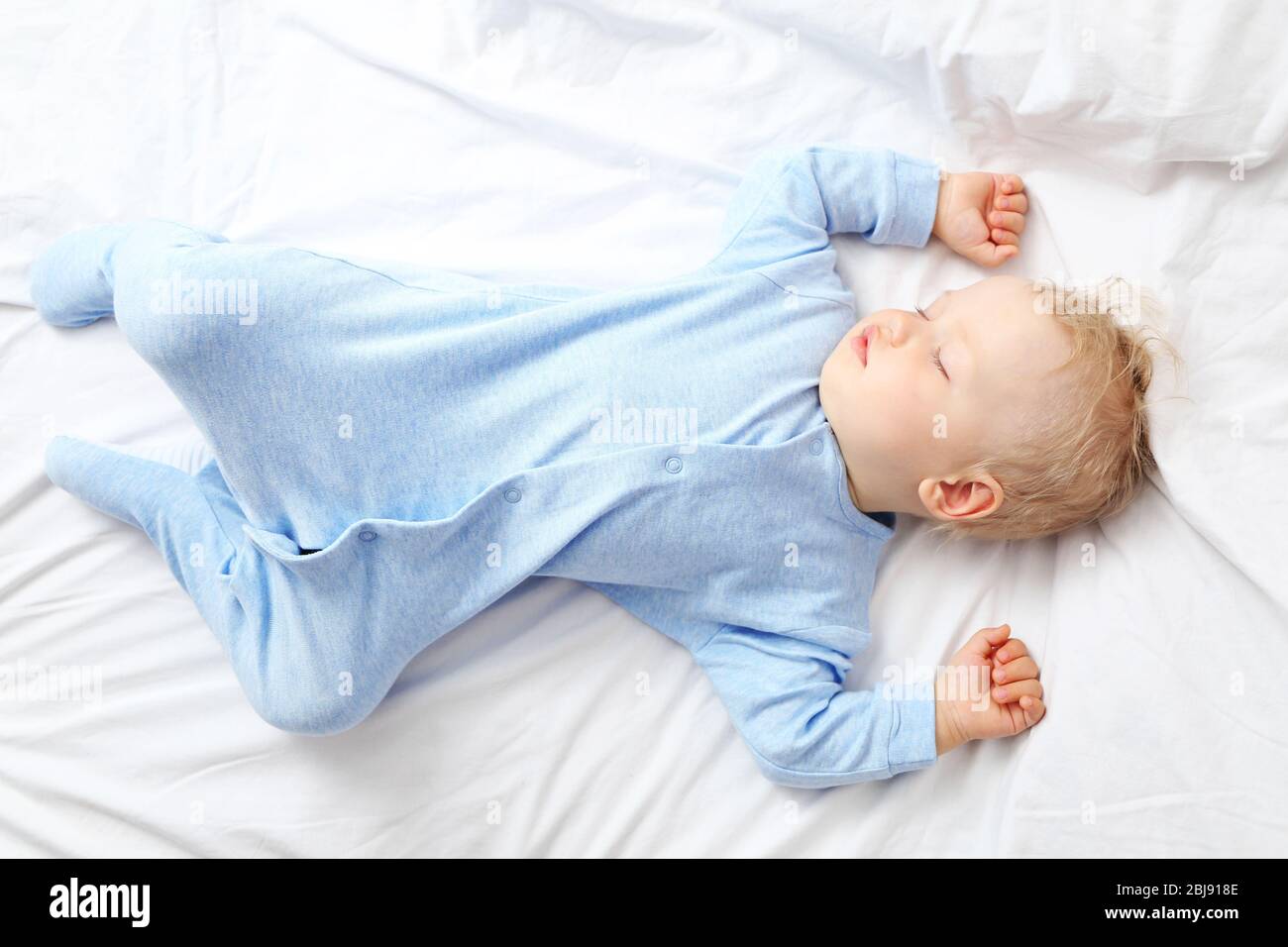 Baby sleeping on bed Stock Photo Alamy