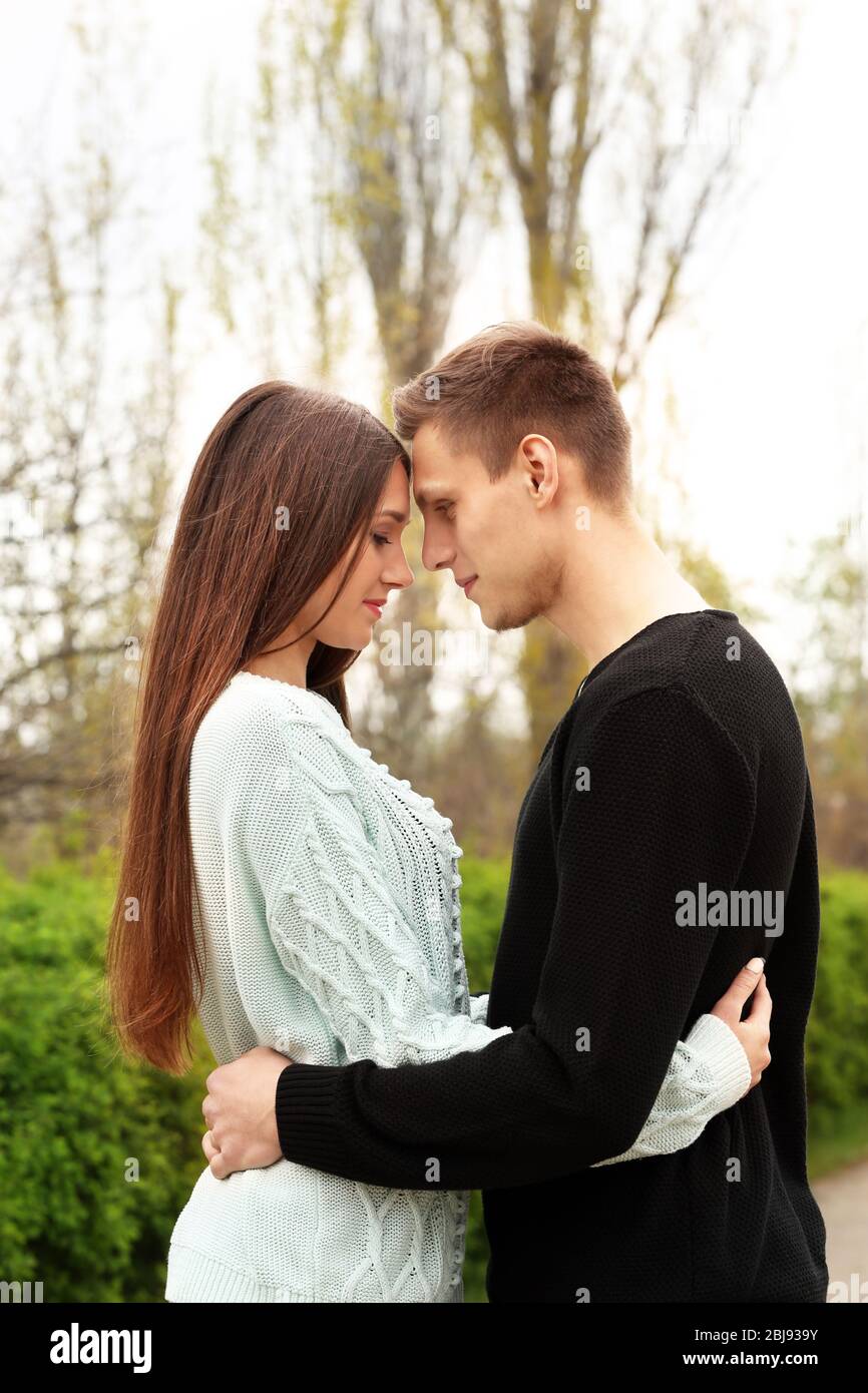 Young couple hugging each other Stock Photo - Alamy