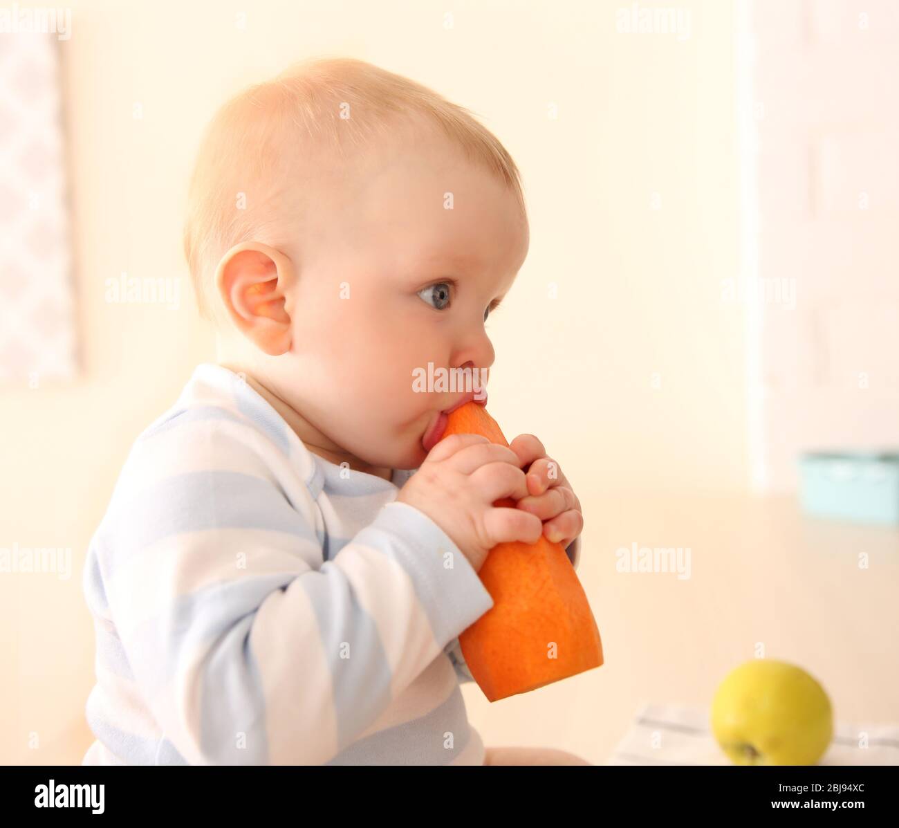 Baby eating carrot hires stock photography and images Alamy