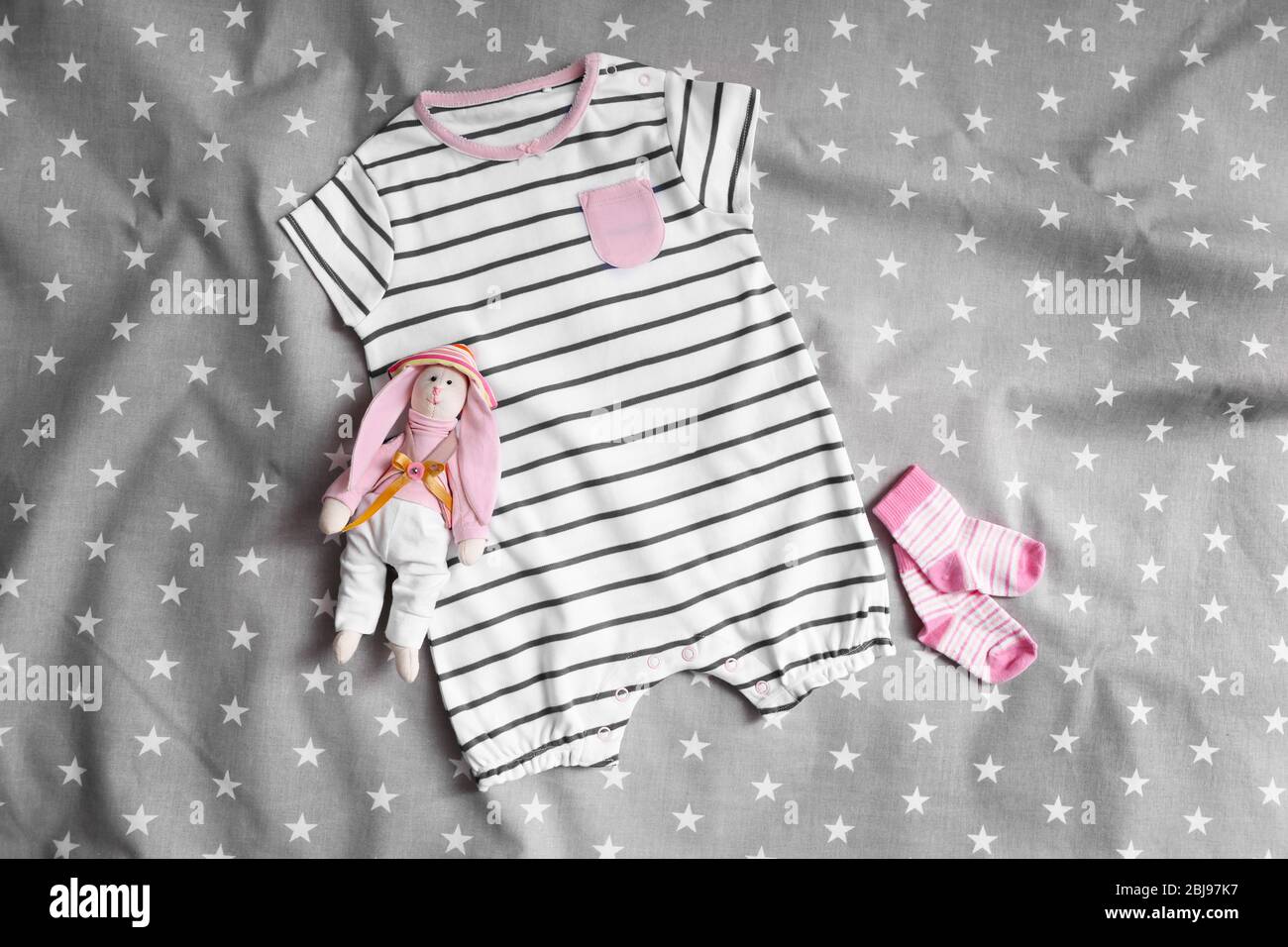 Baby clothes for newborn on grey blanket Stock Photo