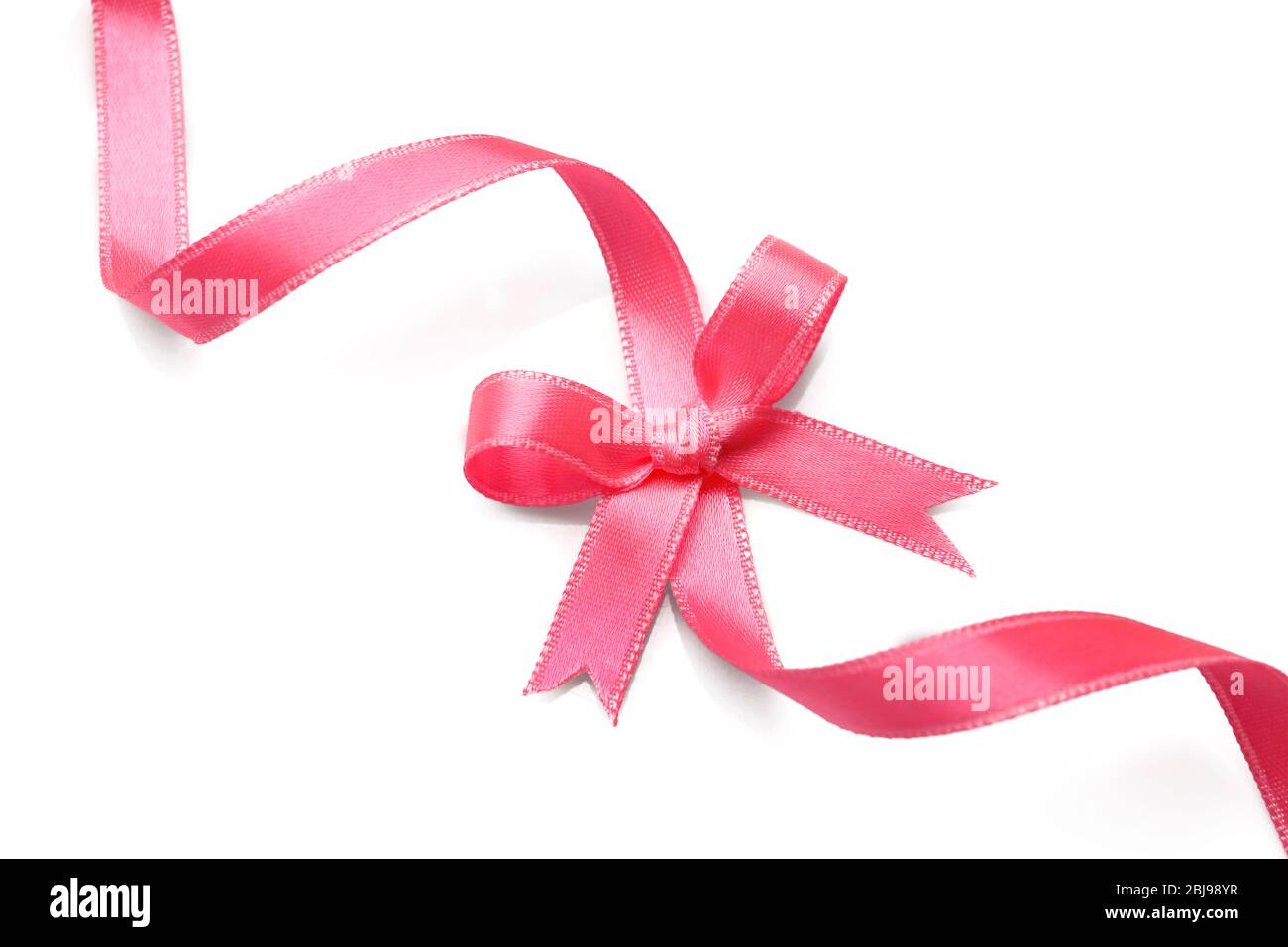 Pink ribbon with bow on white background Stock Photo - Alamy