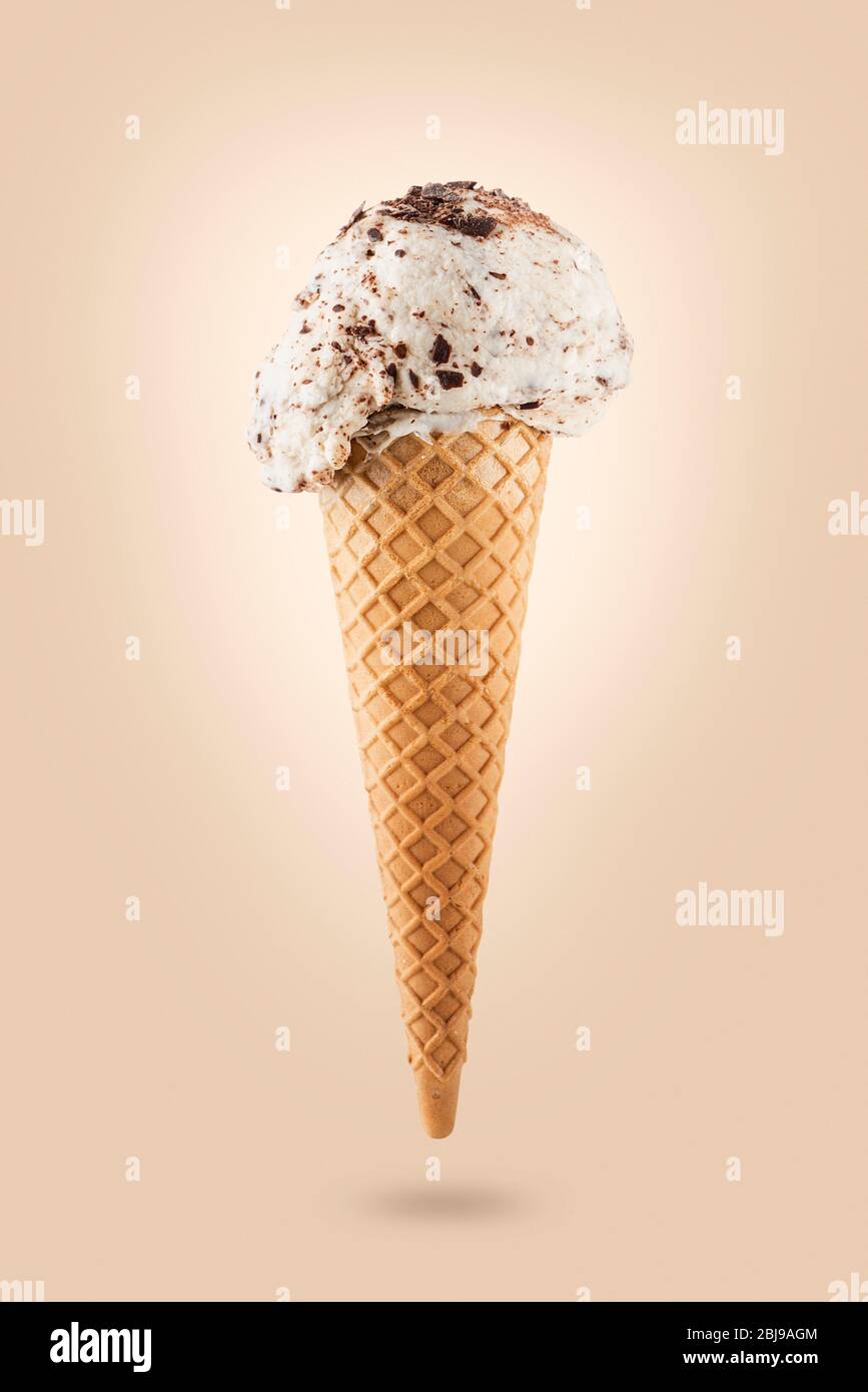 Stracciatella ice cream cone on colored background Stock Photo